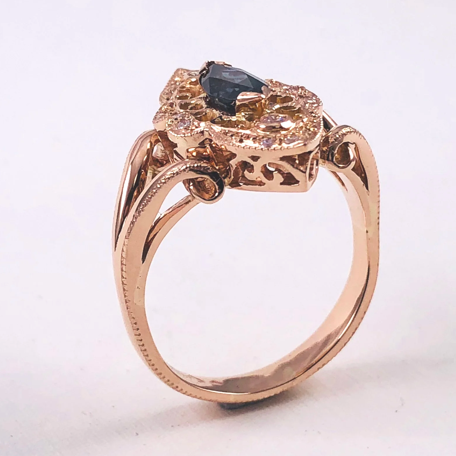 Side view of the finished rose gold colour-change garnet ring with diamond accents