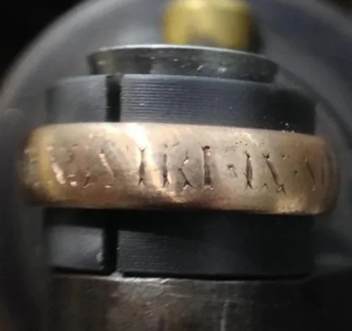 Close-up of worn engraving on a vintage ring.