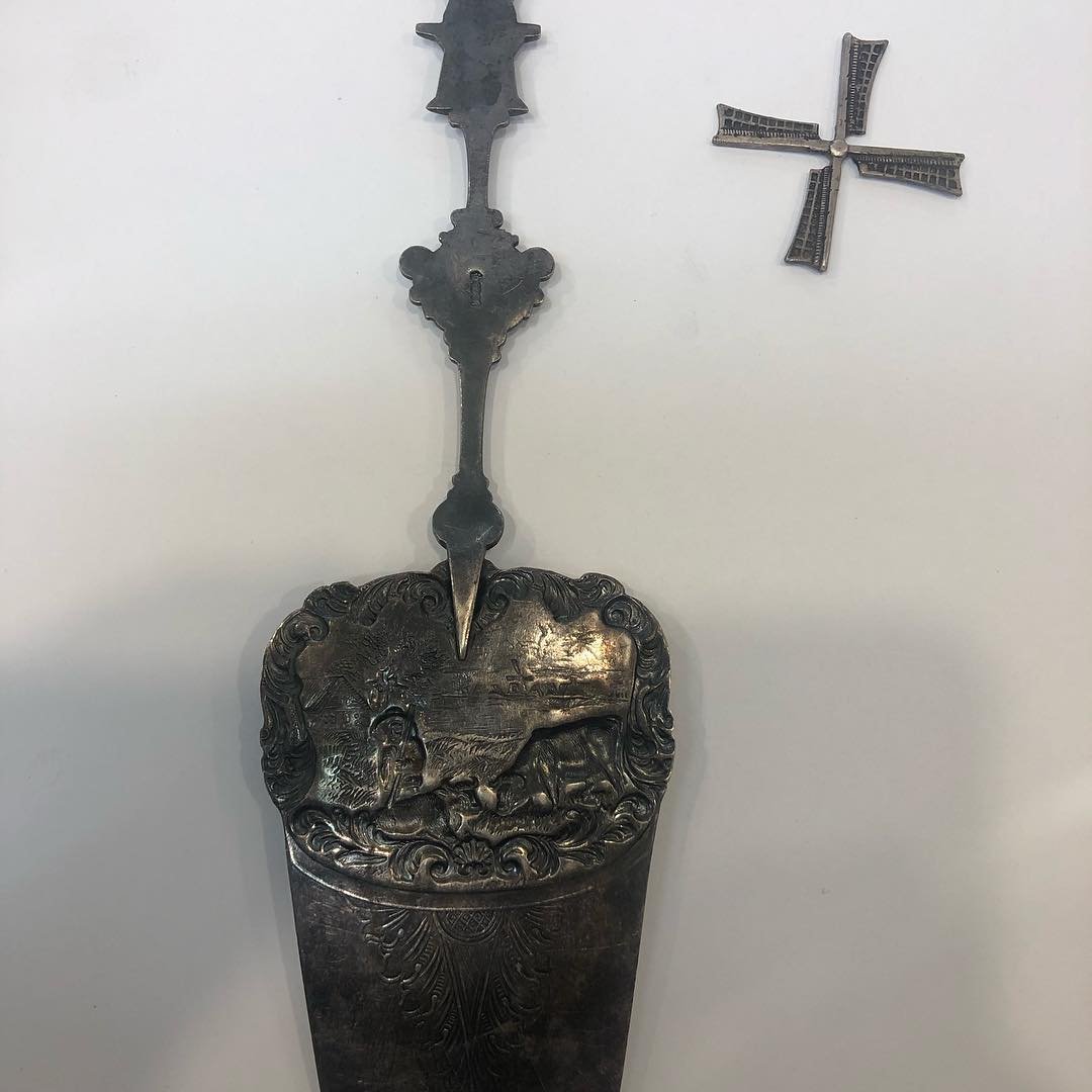 A large vintage silver cake server, with a dutch theme, needing repair.