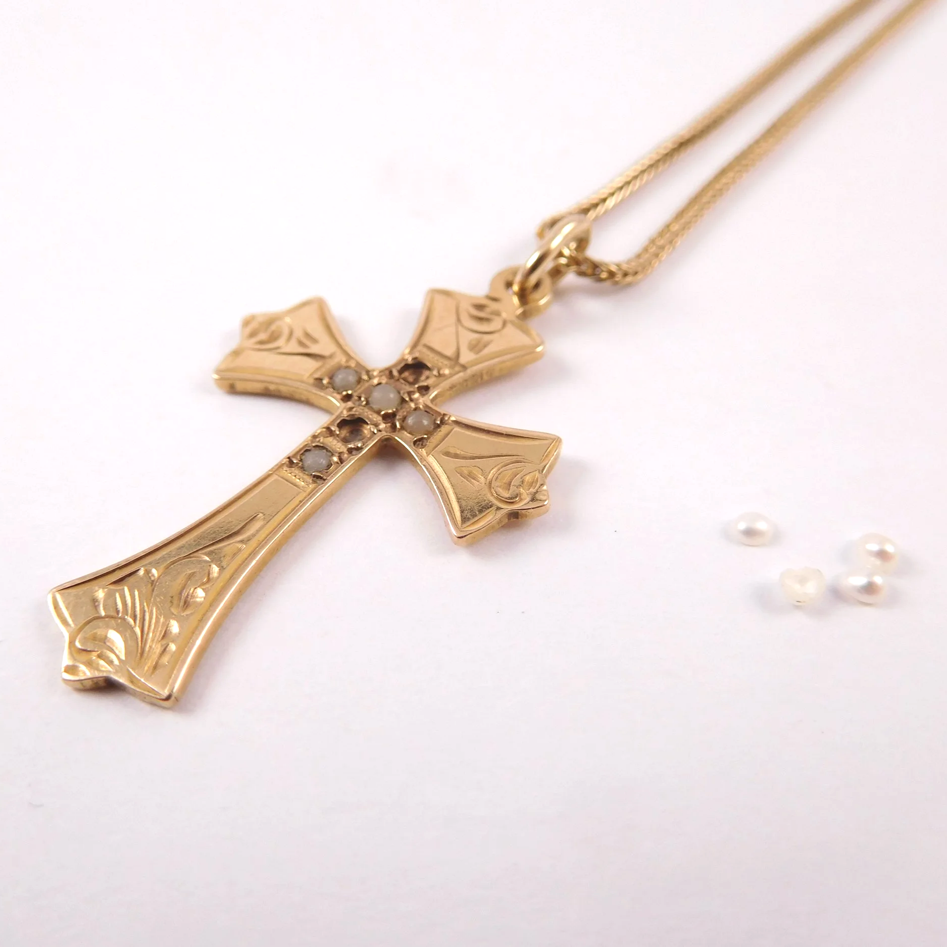 Antique gold cross pendant with missing seed pearls before repair