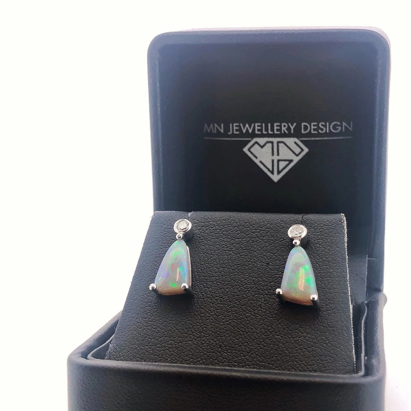 Opal drop earrings in a black display box with 'MN JEWELLERY DESIGN' logo.