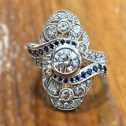 Front view of the handmade Art Deco platinum ring with central diamond and custom-cut sapphires