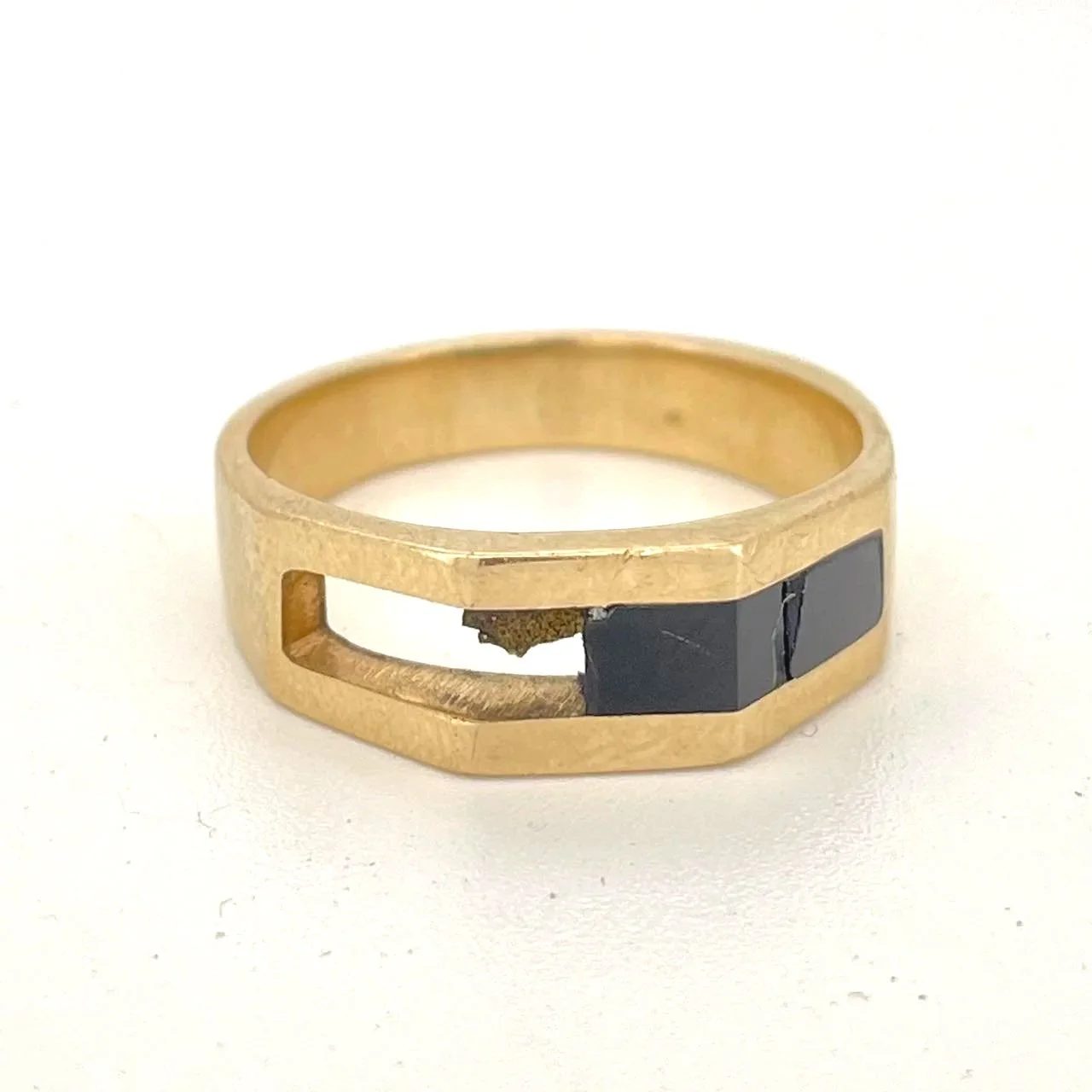 Gold ring with broken black onyx inlay before repair