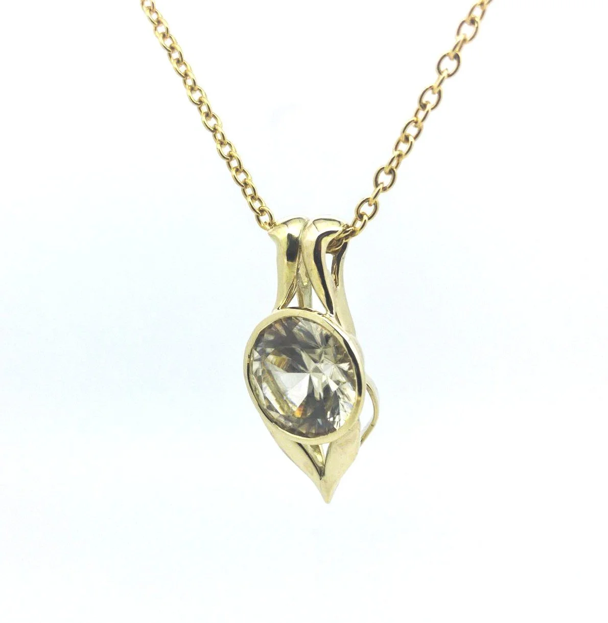 Gold necklace with a pendant featuring a large clear gemstone