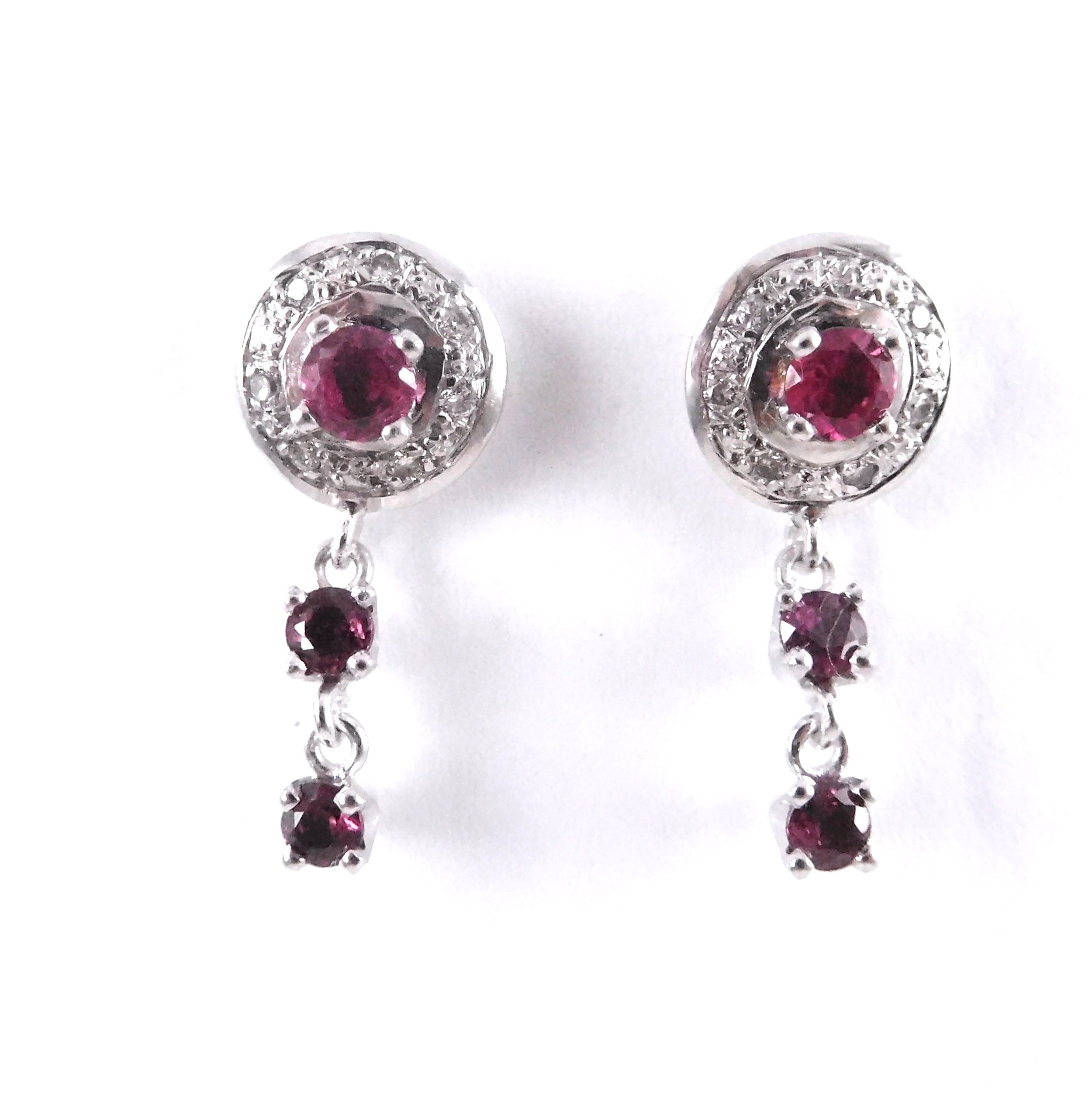 Pair of white gold earrings with pink gemstones surrounded by small clear stones