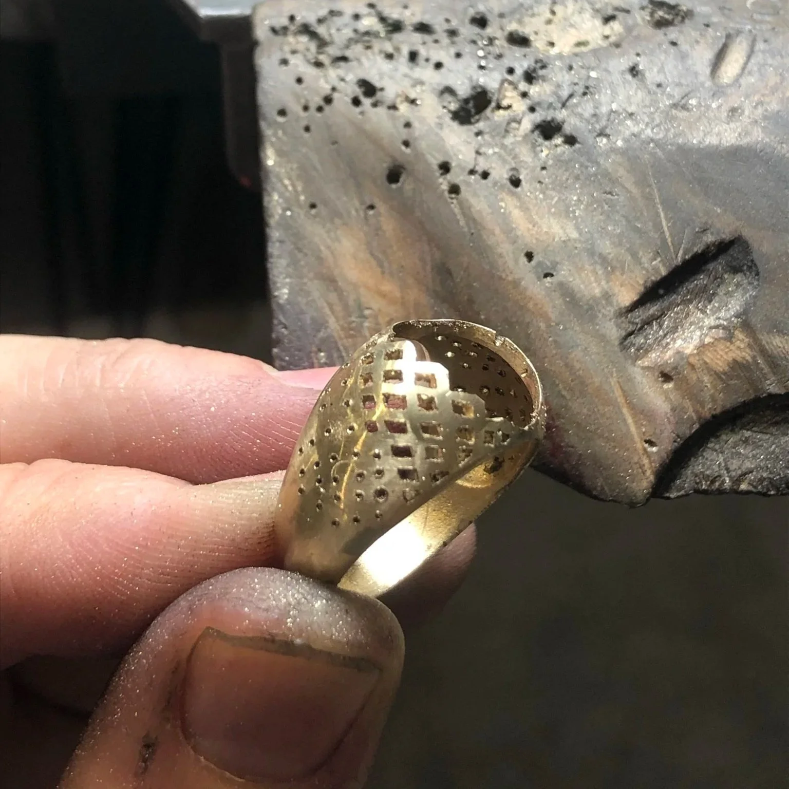 Hand-pierced yellow gold ring band before final assembly