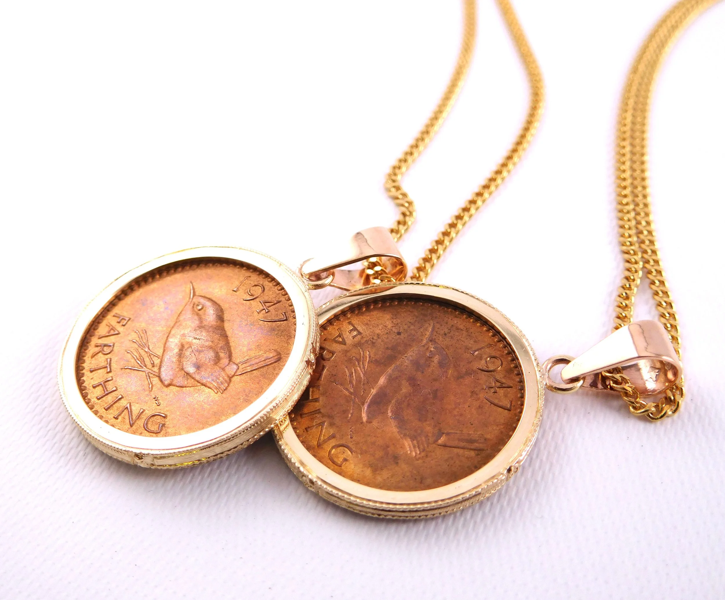 Old penny coins as pendants on a gold necklace