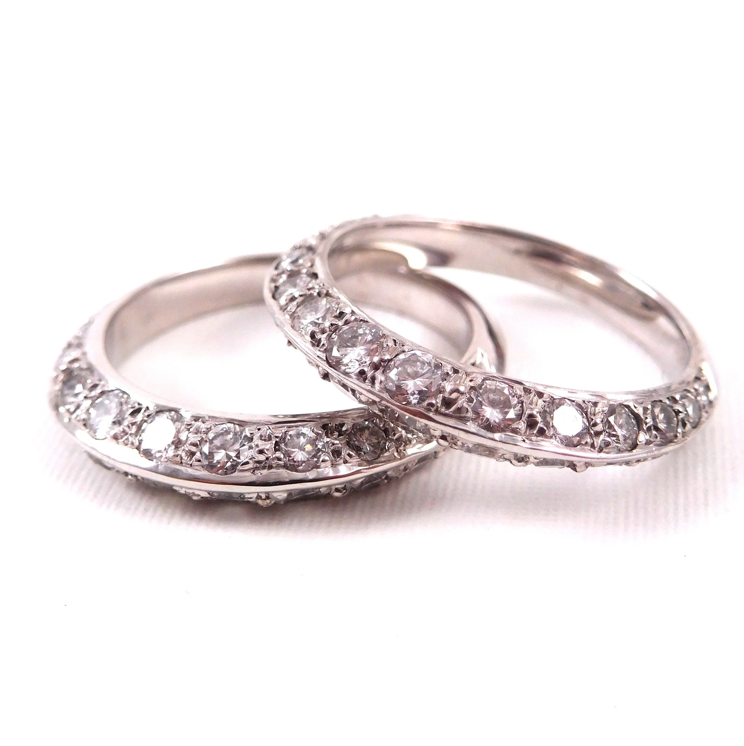 Close-up of white gold rings with embedded diamonds. 