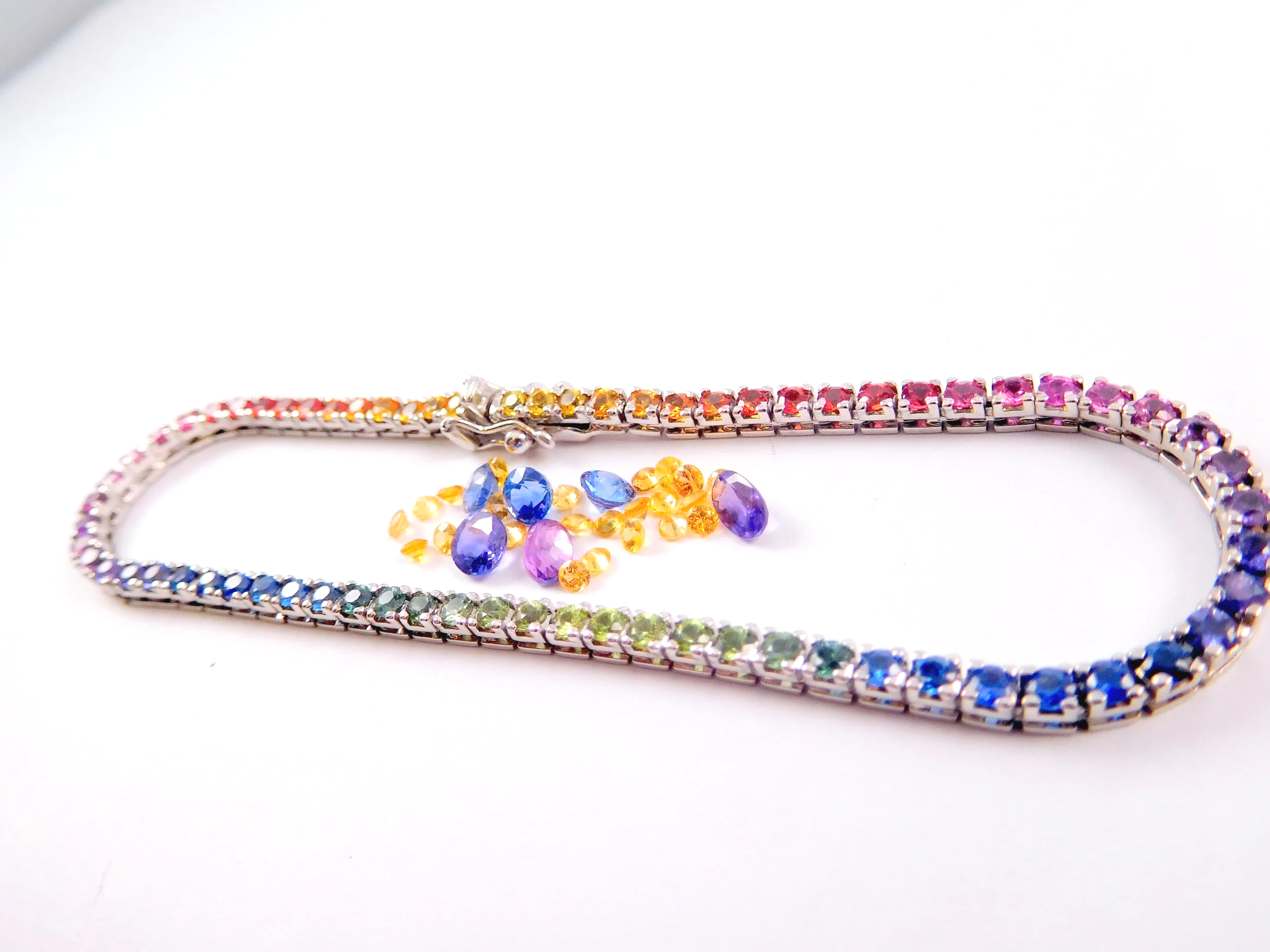 Colorful rainbow jewelry including a statement necklace with multicolored gemstones
