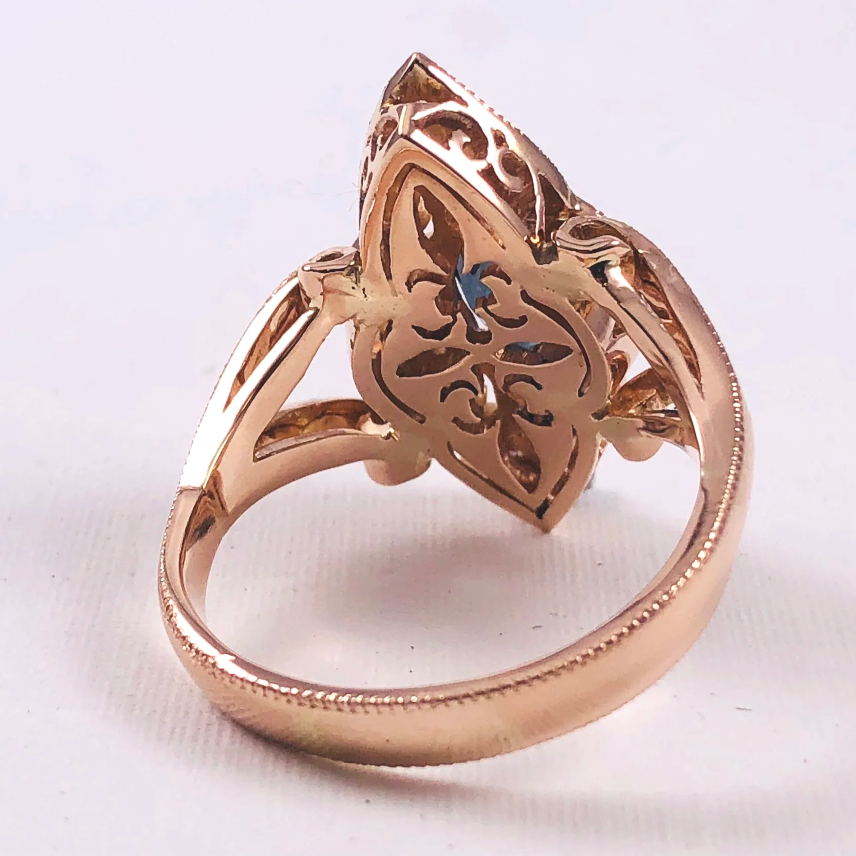 Underside of the finished rose gold ring showing the hand-pierced gallery design