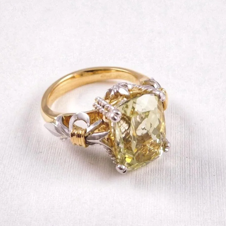 Finished hiddenite dress ring showing handmade gold and platinum detailing