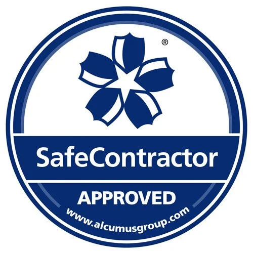 A circular logo for SafeContractor with a blue and white color scheme, featuring a stylized flower at the top, the words "SafeContractor" in the center, and the word "APPROVED" at the bottom, along with a website URL www.alcumusgroup.com.