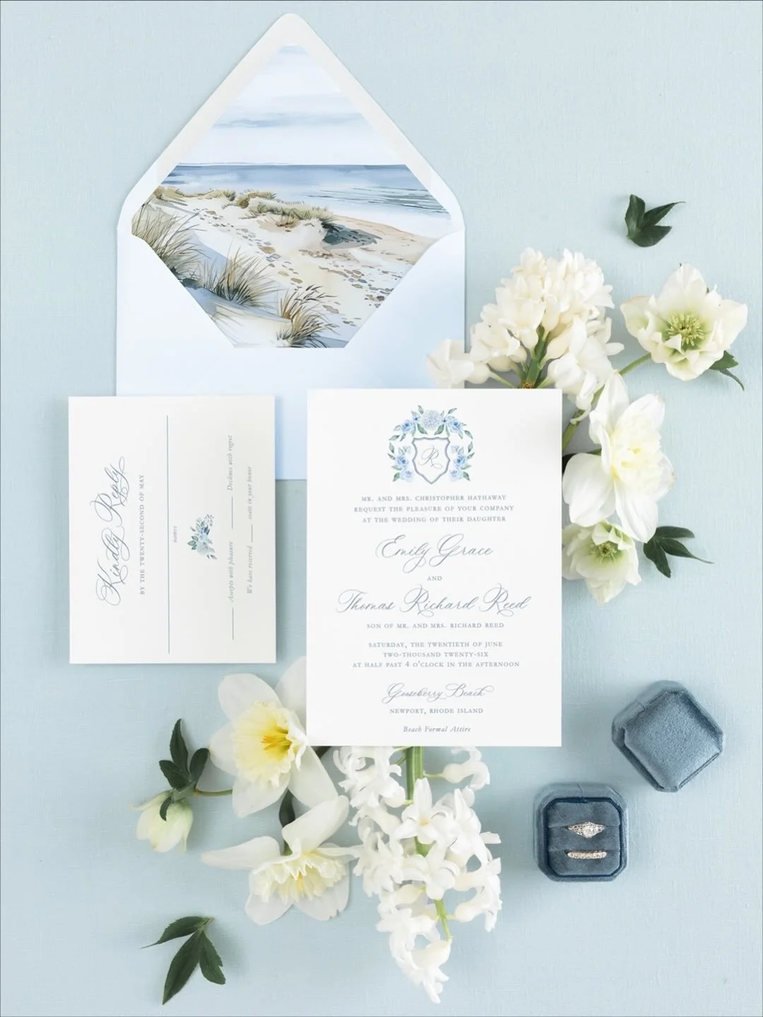 Wedding invitation for a Newport,  Rhode Island summer wedding with floral details, seaside painting in envelope, wedding rings in box, white flowers