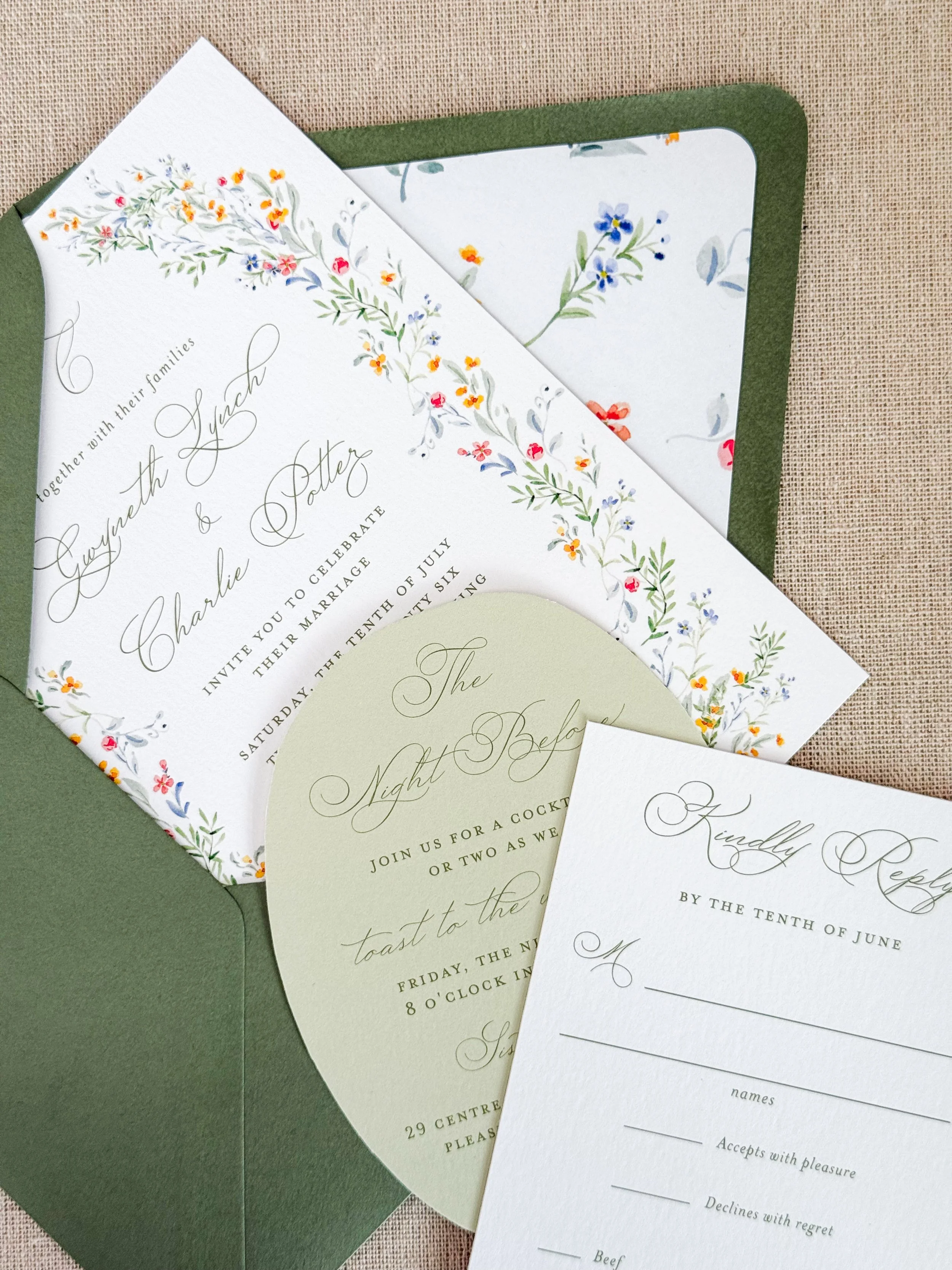 Wedding invitations with floral designs, including a main invitation card, RSVP card, and a circular event detail card, all in elegant script fonts and pastel colors, placed on a textured surface.
