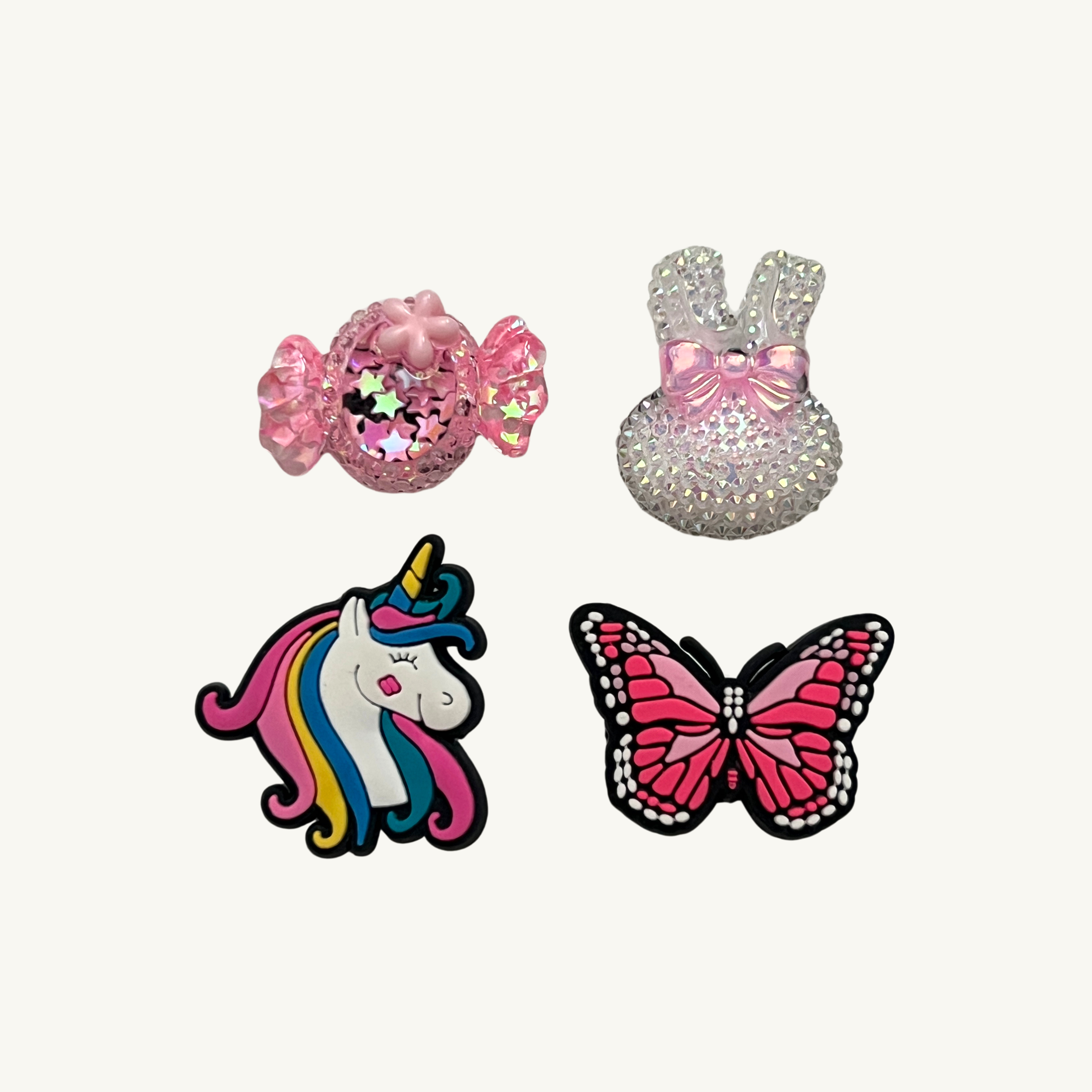 Pink candy, sparkle bunny, unicorn, and butterfly 4-pack charm set by CharmyKidz for customizable hair accessories