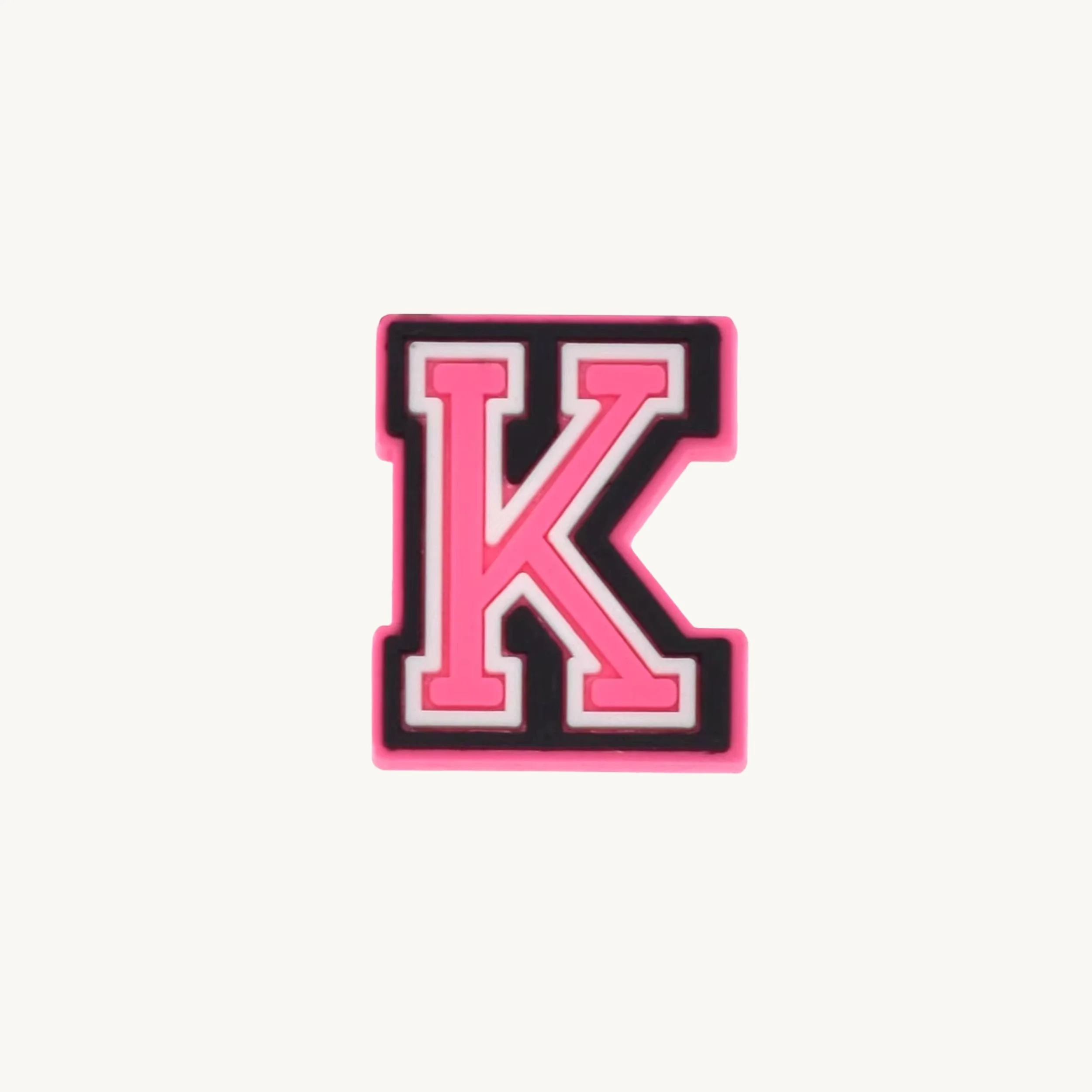 Pink varsity initial letter K charm by CharmyKidz for customizable hair accessories
