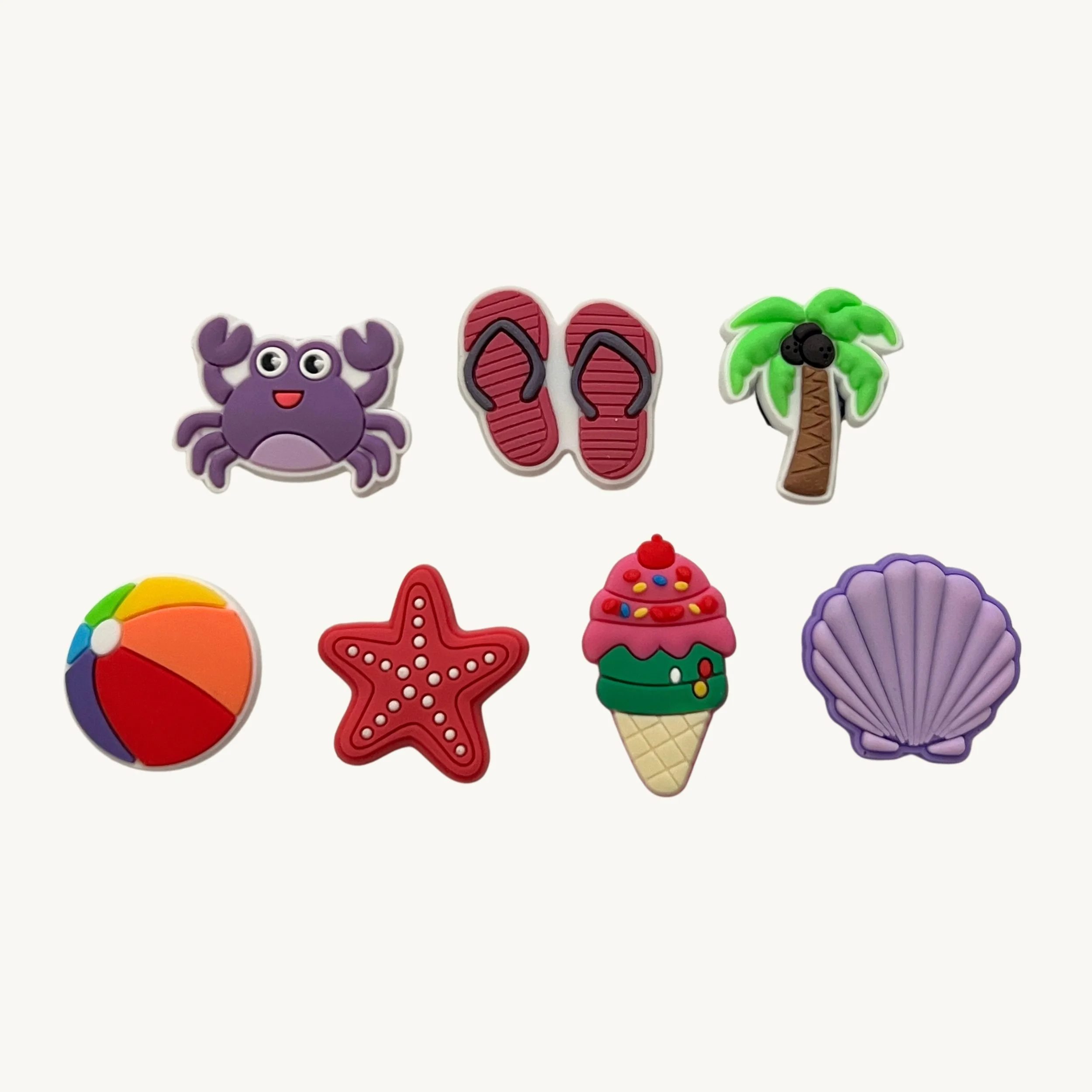 Crab, flip flops, palm tree, beach ball, starfish, ice cream, and seashell 7-pack charm set by CharmyKidz for customizable hair accessories