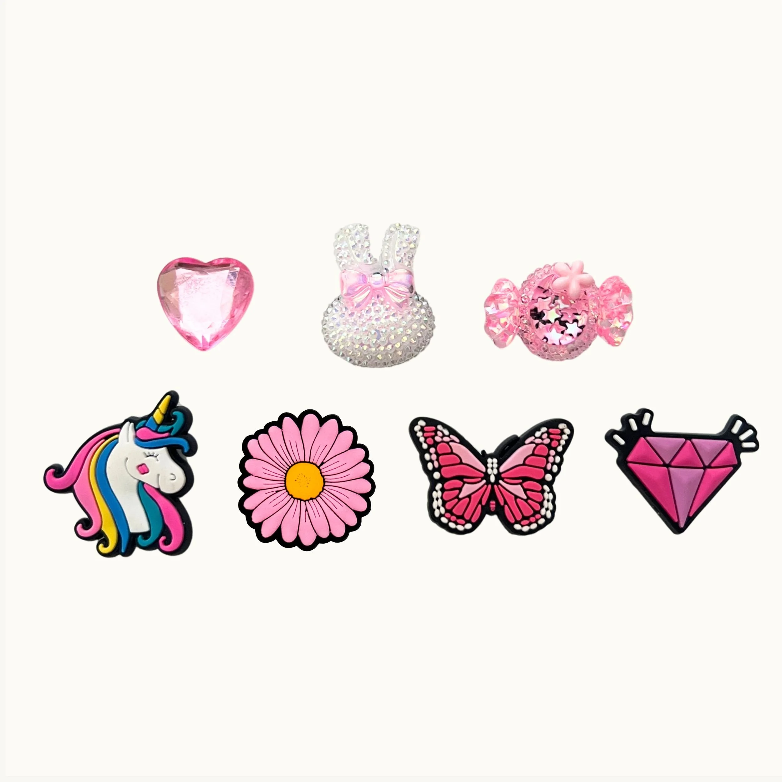 Pink gem heart, sparkle bunny, candy, unicorn, daisy, butterfly, and diamond 7-pack charm set by CharmyKidz for customizable hair accessories