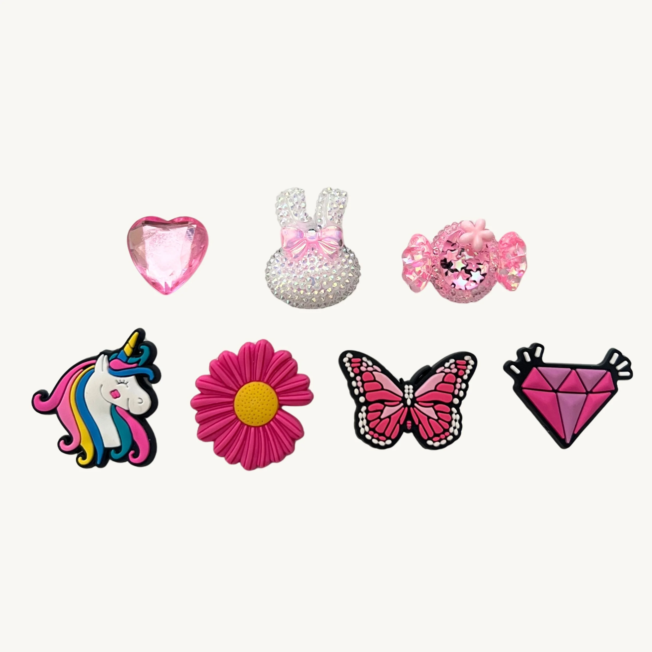 Pink gem heart, sparkle bunny, candy, unicorn, daisy, butterfly, and diamond 7-pack charm set by CharmyKidz for customizable hair accessories