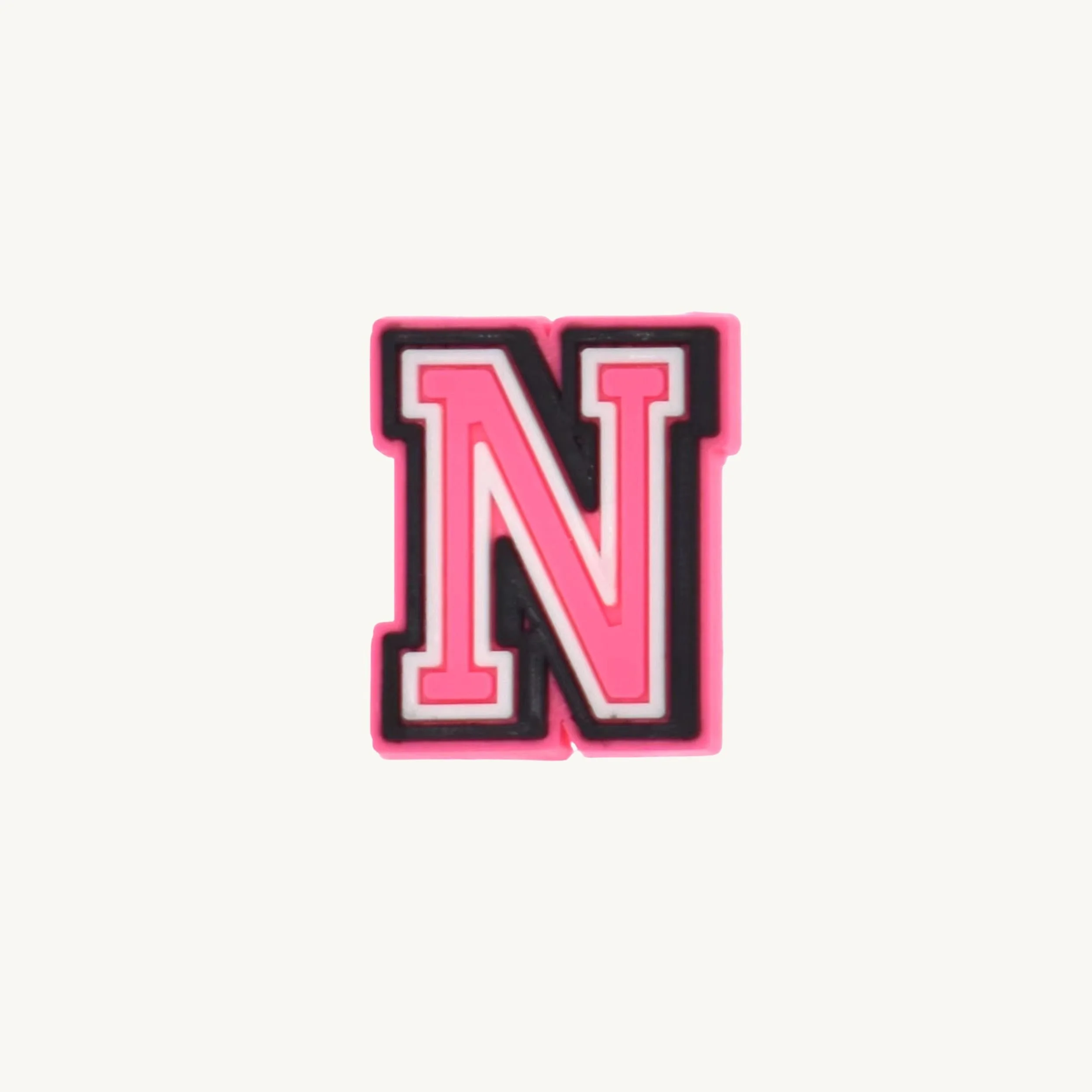 Pink varsity initial letter N charm by CharmyKidz for customizable hair accessories
