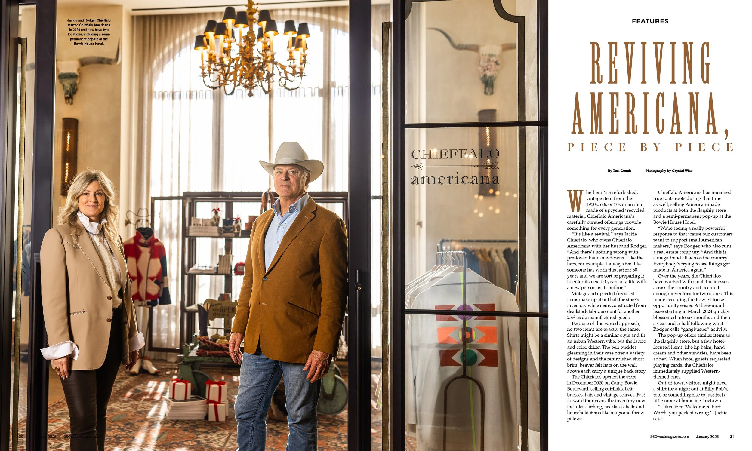 A man wearing a tan blazer, light blue shirt, and a cowboy hat standing inside a boutique, with a woman in a beige blazer and black pants standing nearby. The store features vintage decor, clothing displays, and a large chandelier.
