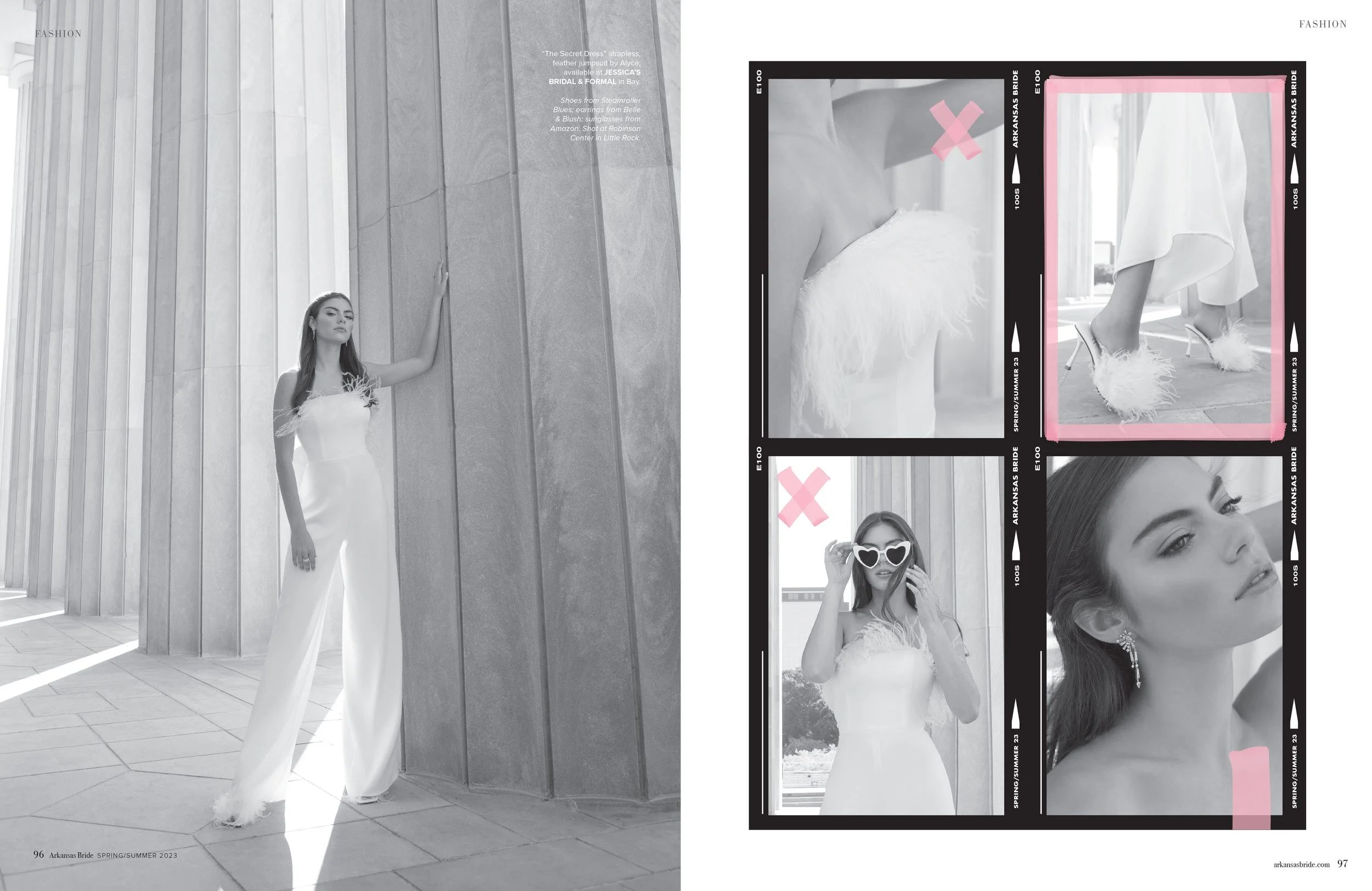 A model in a white wedding jumpsuit with feather details on the shoulders standing outdoors against large stone columns with sunlight casting shadows.