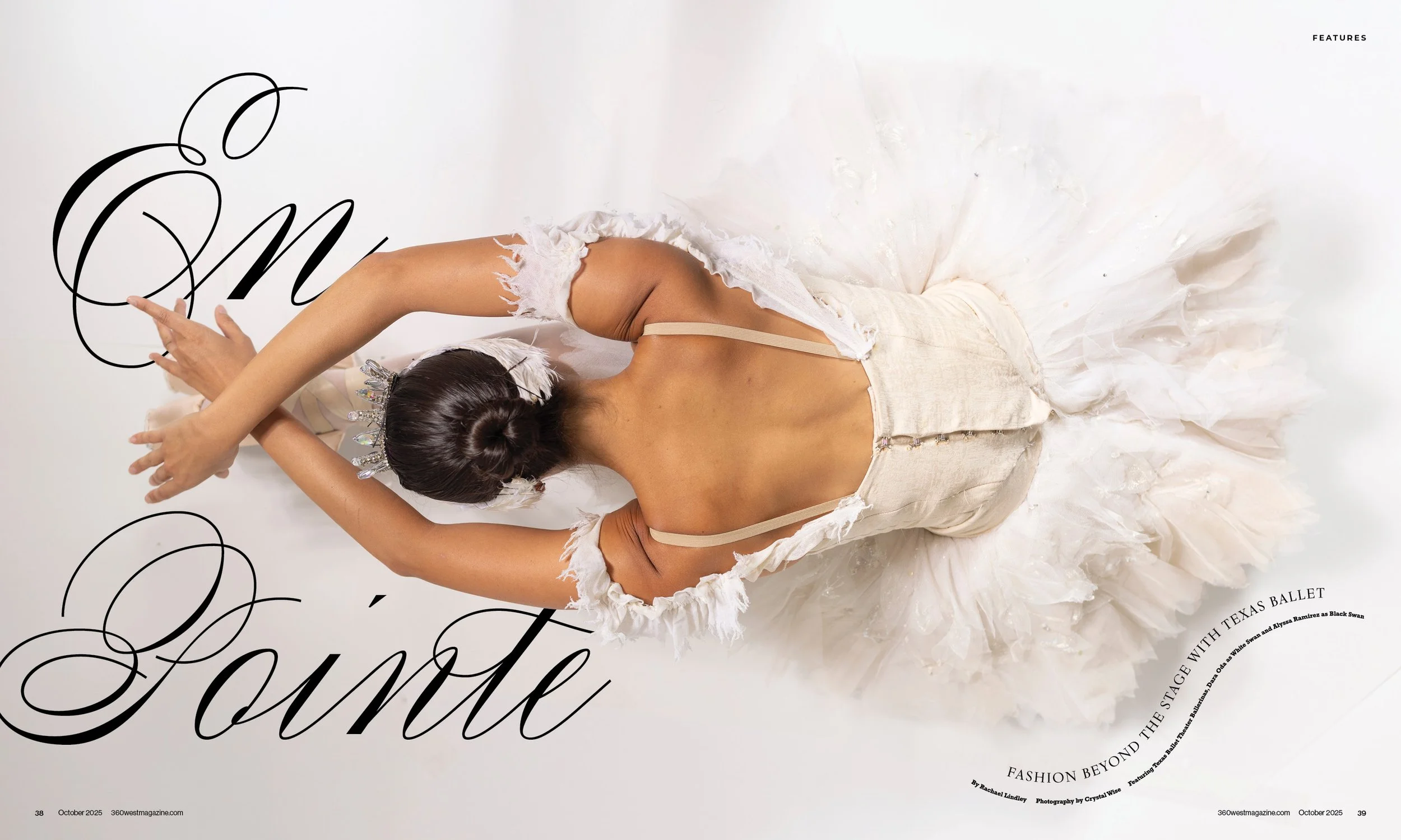 A ballerina in a white tutu and beige costume, with her hair in a bun and wearing a tiara, posing with her back to the camera against a white background.