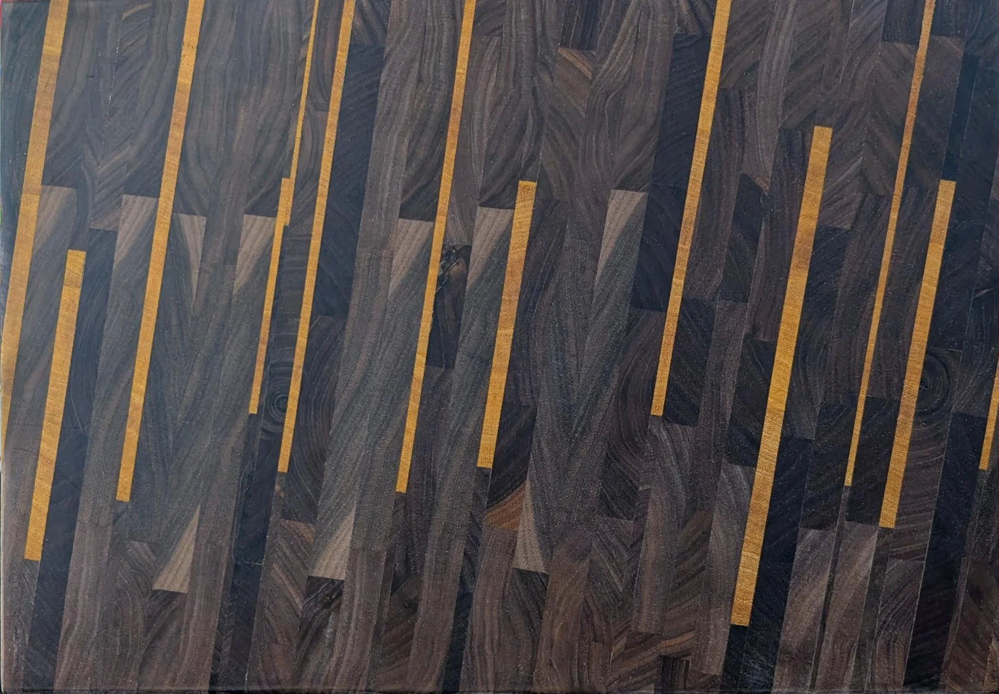 Patterned wooden floor with alternating dark and light-colored planks arranged in a diagonal pattern.