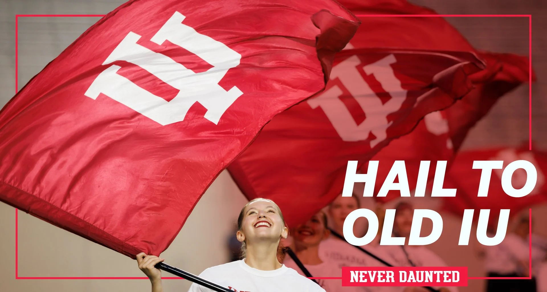 a female raises and IU trident flag with the words "Hail to Old IU" overlaid