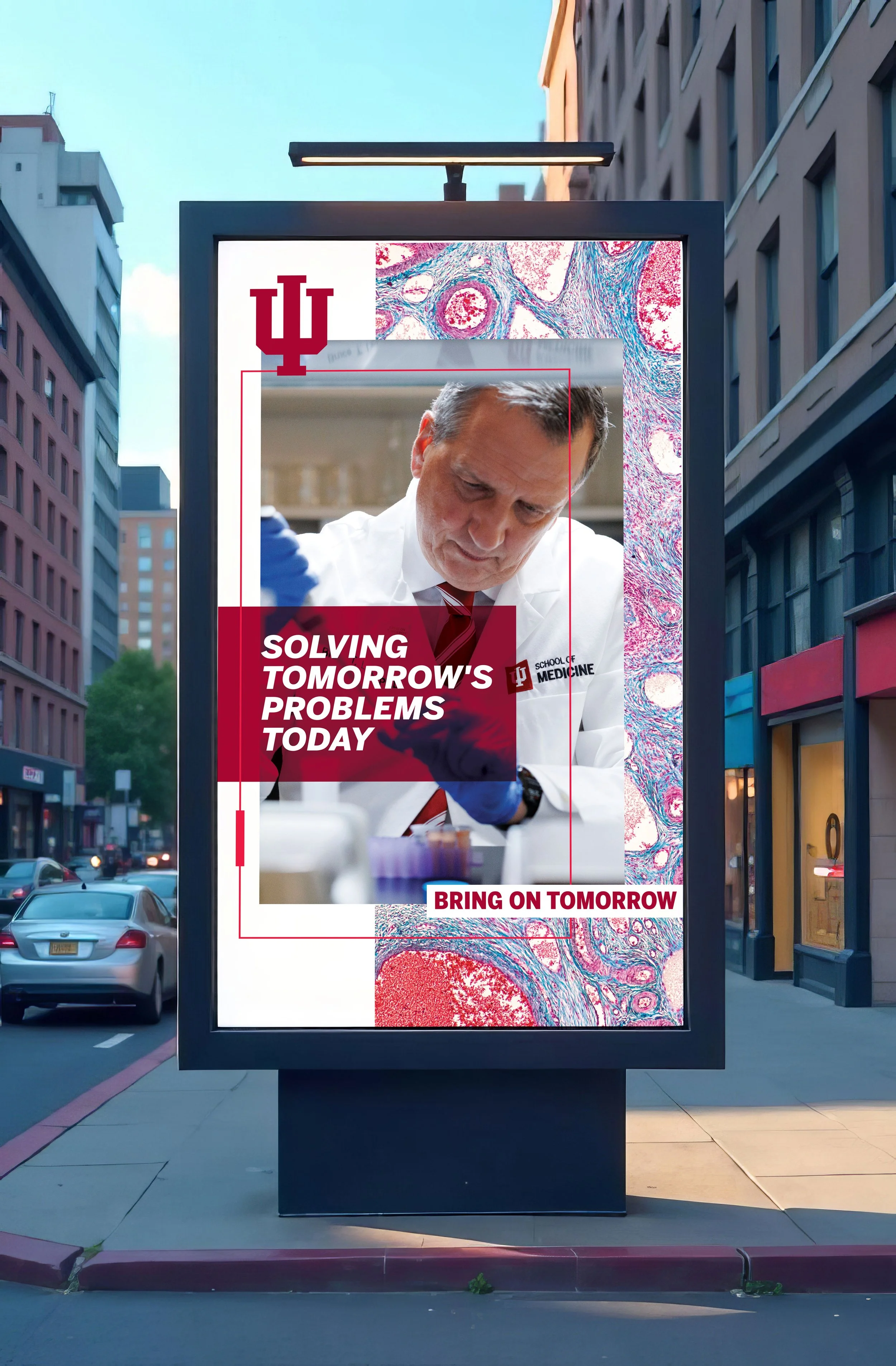 Image of a digital kiosk reading "Solving tomorrow's problems today" with a layered image featuring a male scientist in a white coat and blue gloves in a lab
