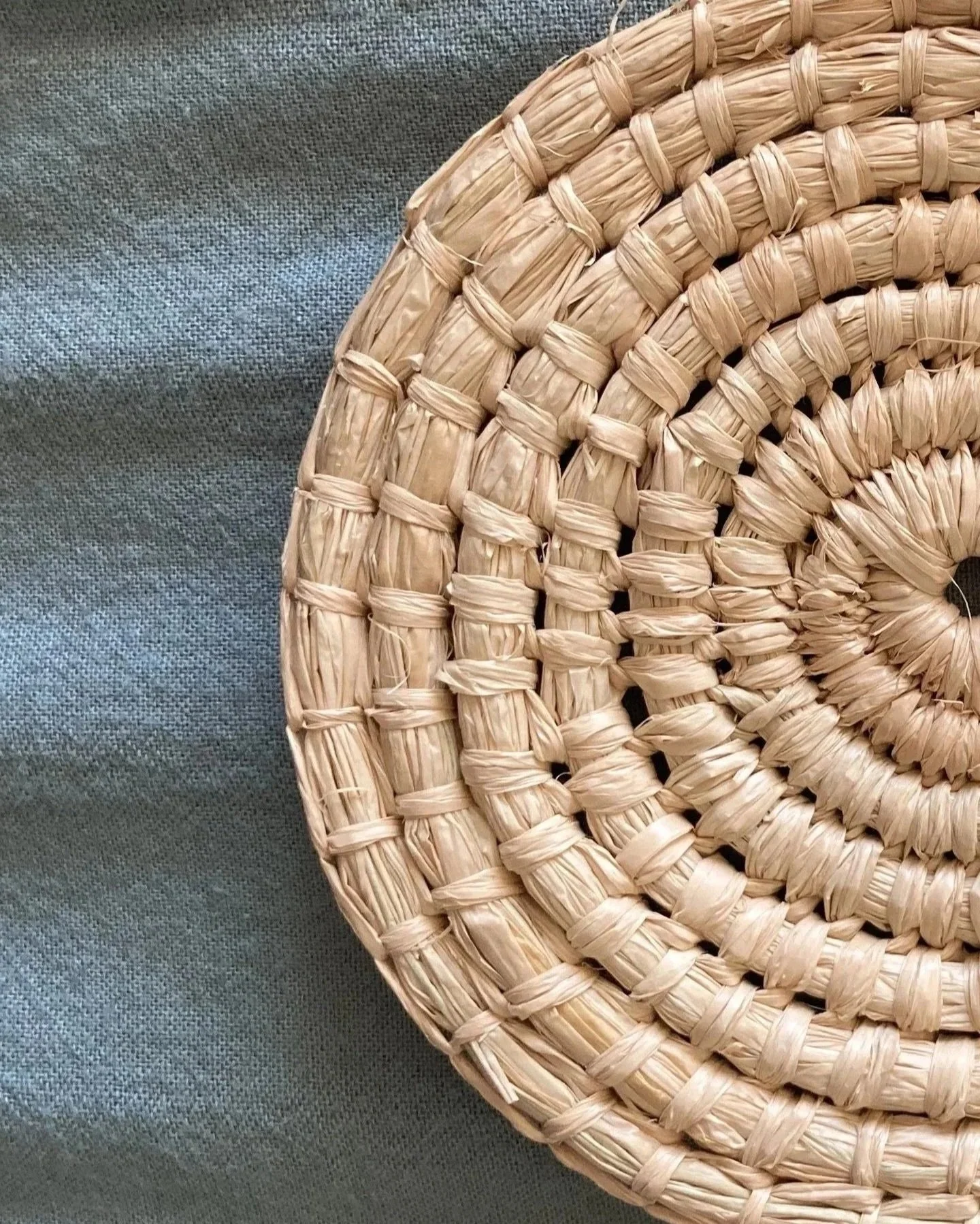 Close-up of a round raffia woven placemat.