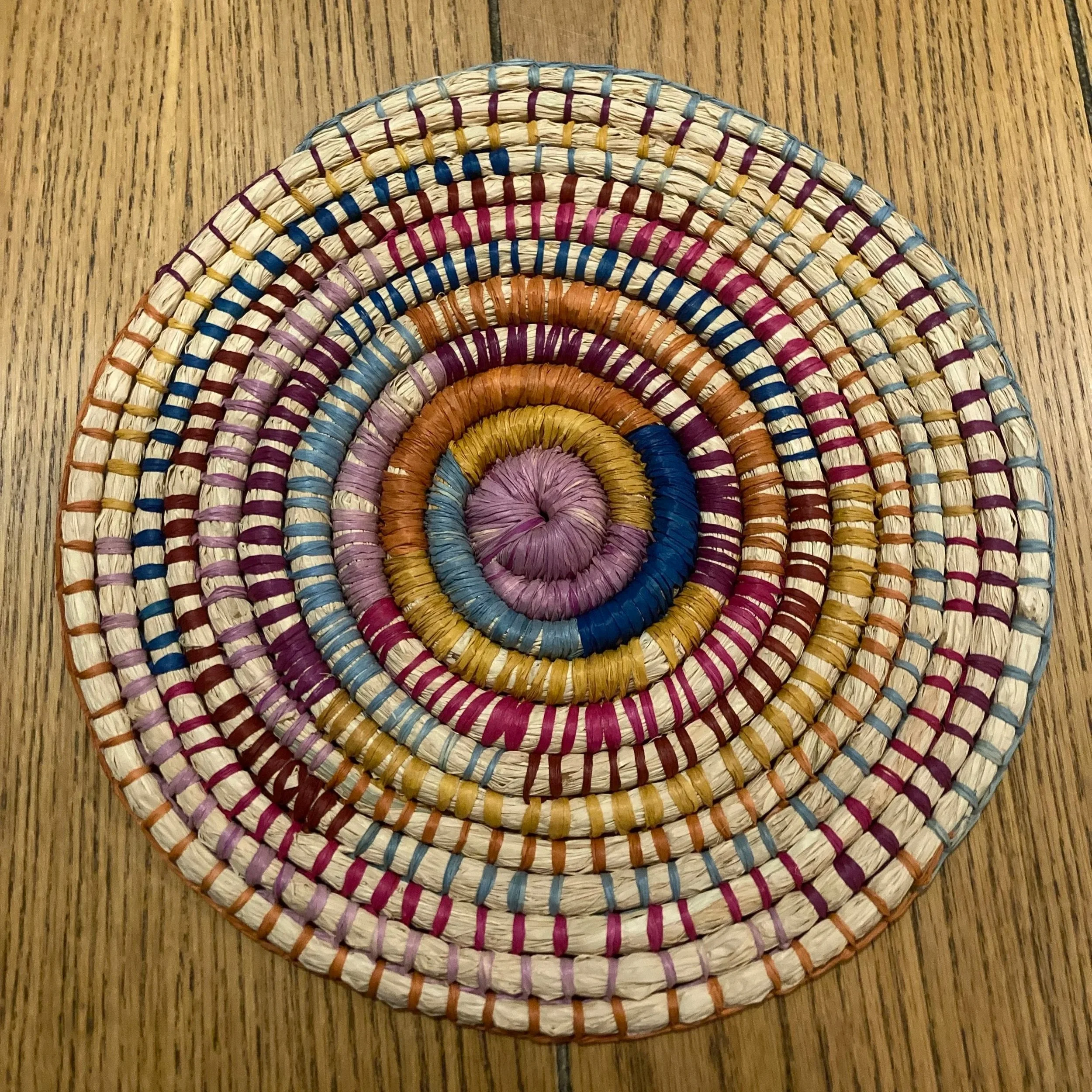Colorful woven spiral placemat.