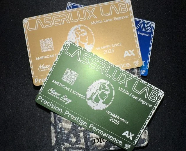 LaserLux Lab metal business cards in gold, green, and blue finishes