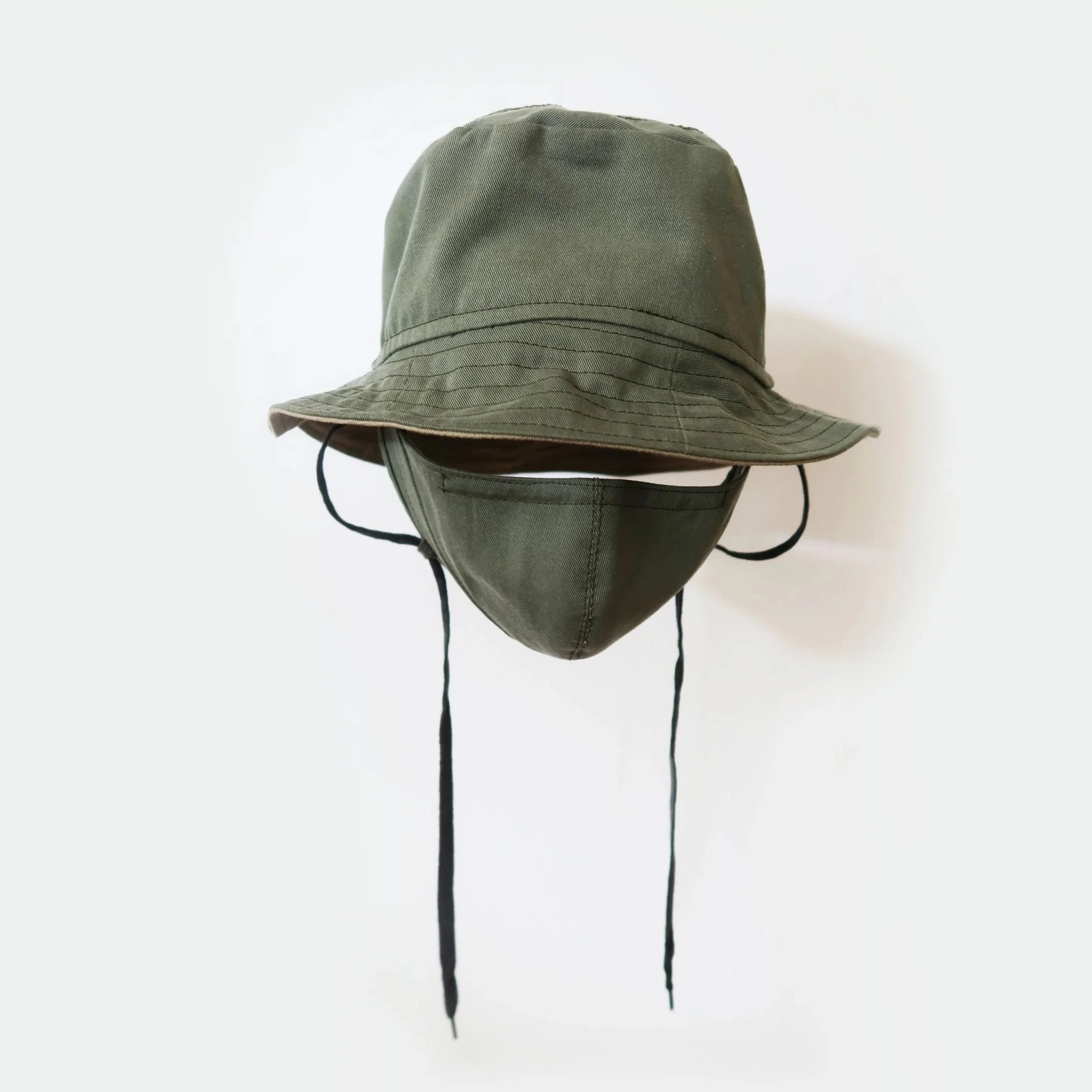 A khaki-colored wide-brimmed hat with adjustable chin straps, positioned against a white background.