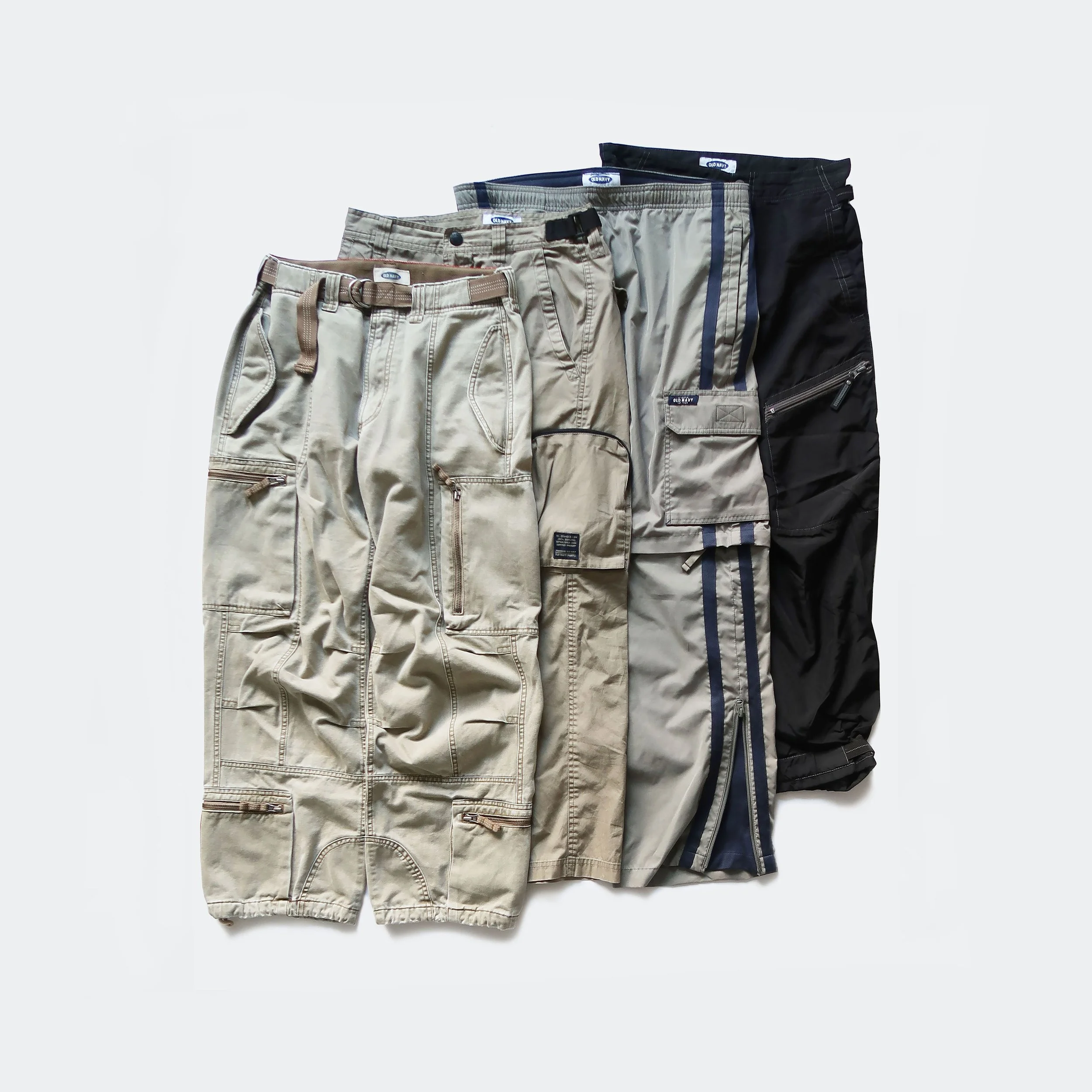 Five pairs of men's cargo shorts in beige, khaki, navy, gray, and black, arranged vertically against a plain white background.