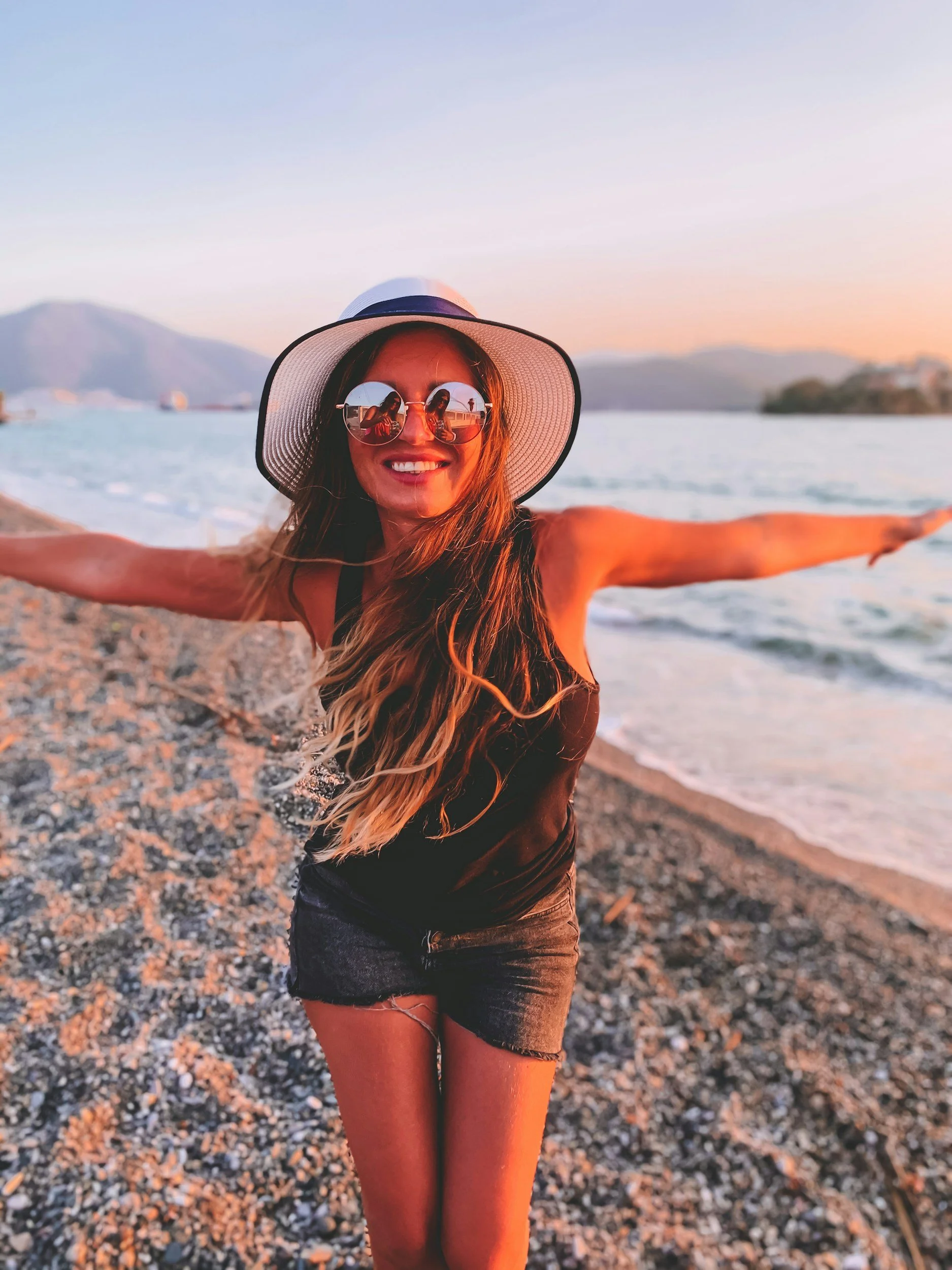Woman on a sandy beach. FAQ on individual sex therapy for intimate trauma, low libido, ED, desire discrepancies, or performance anxiety with Lisa Olinger in Ann Arbor Michigan.