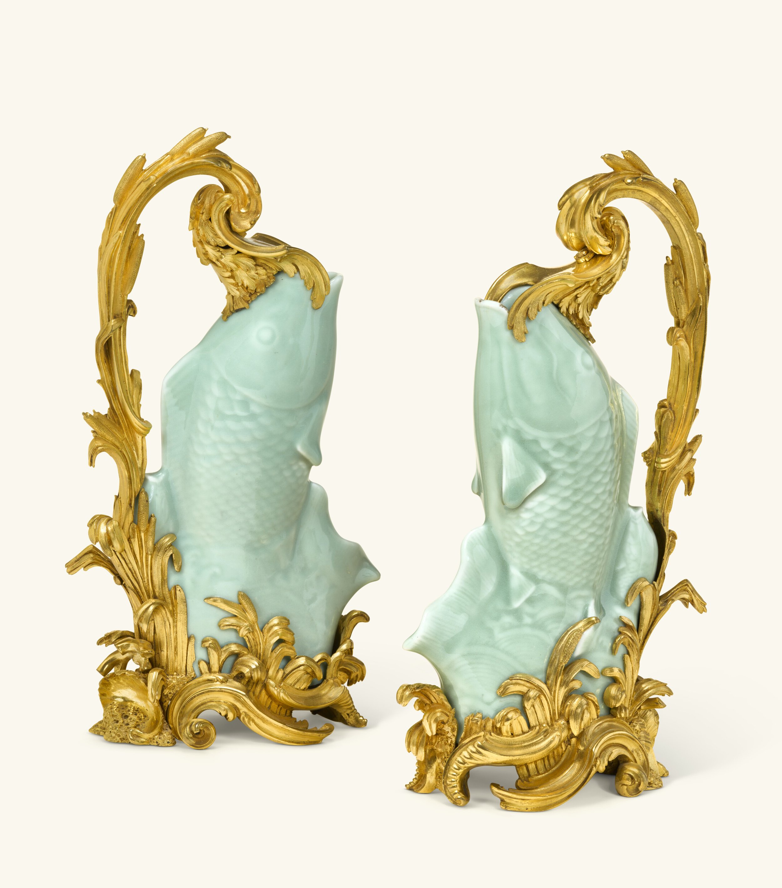 A pair of Louis XV ormolu-mounted Chinese celadon porcelain ewers, almost certainly supplied by Lazare Duvaux, the porcelain Qianlong period (1735-1795), the mounts circa 1750-1755. 12½ in (32 cm) high.