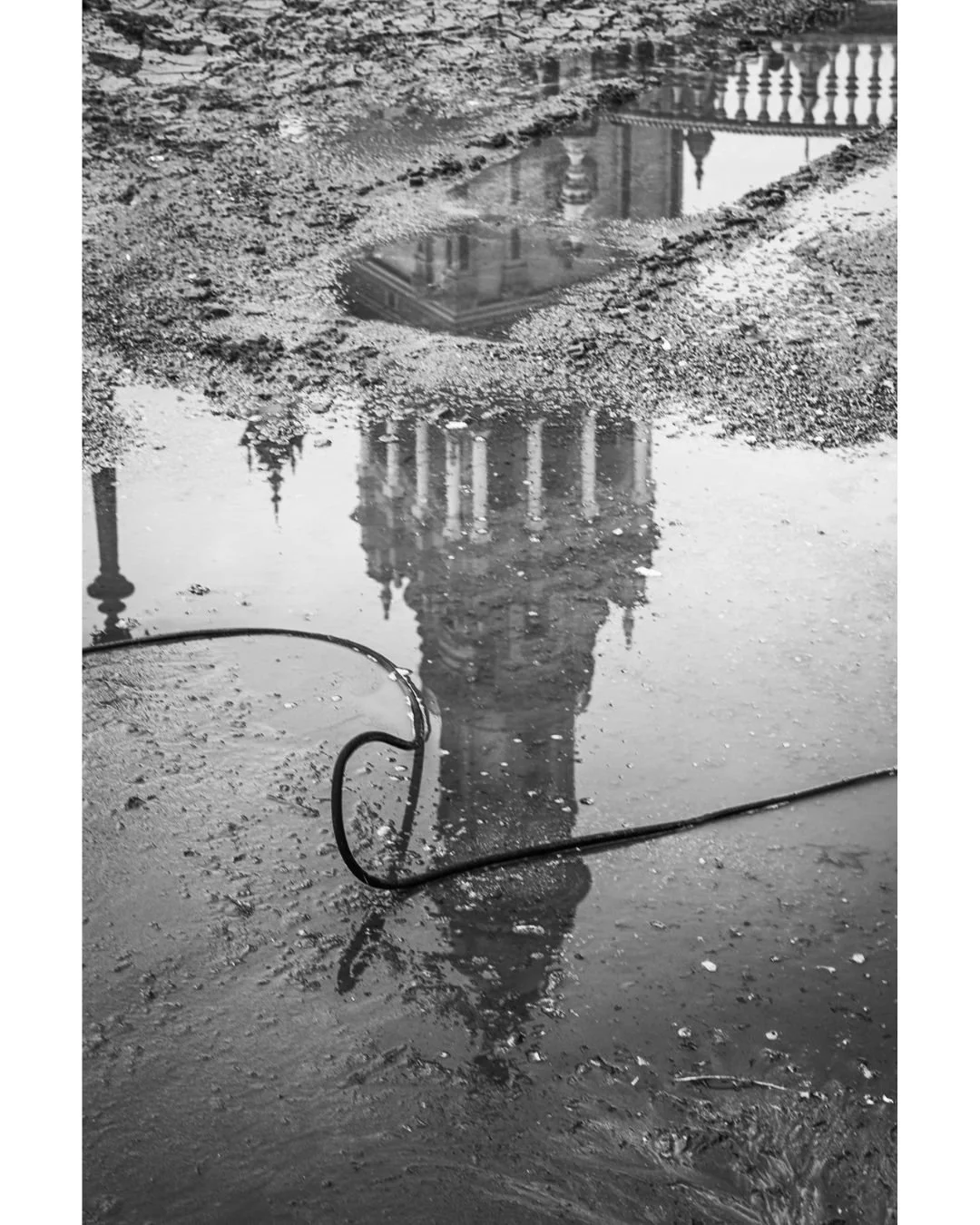 Mirroring the monumental. The Plaza de Espa&ntilde;a tower reflected not in water, but in the textures of temporary mud during the cleaning of the moat. Imperfect, but beautiful.

Reflejando lo monumental. La torre de Plaza de Espa&ntilde;a, reflejad