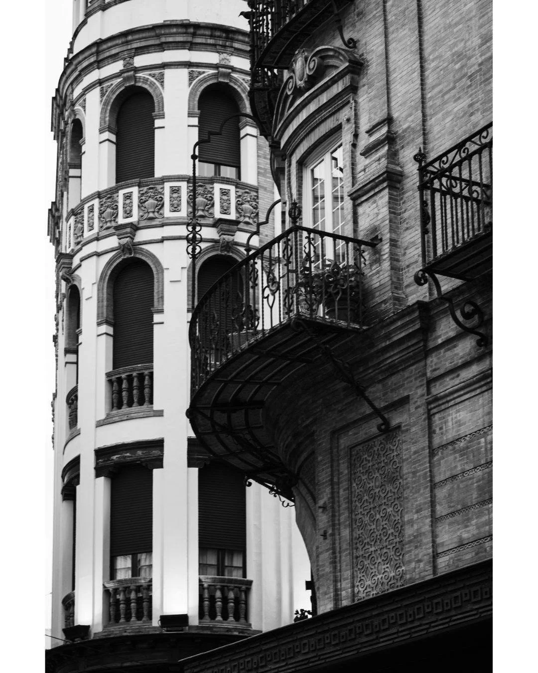 The rhythm of the city is found in its vertical lines. These iron balconies and curved facades are more than just architecture; they are the stage for everyday life in Seville. I look for these patterns to provide a sense of place and timelessness to