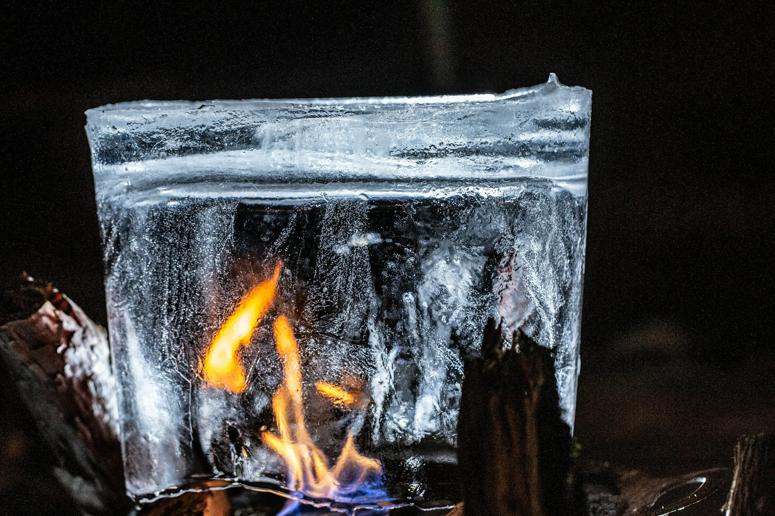 An image depicting the contrast of hot and cold. Fire and Ice, symbolic of a sauna and an ice bath.
