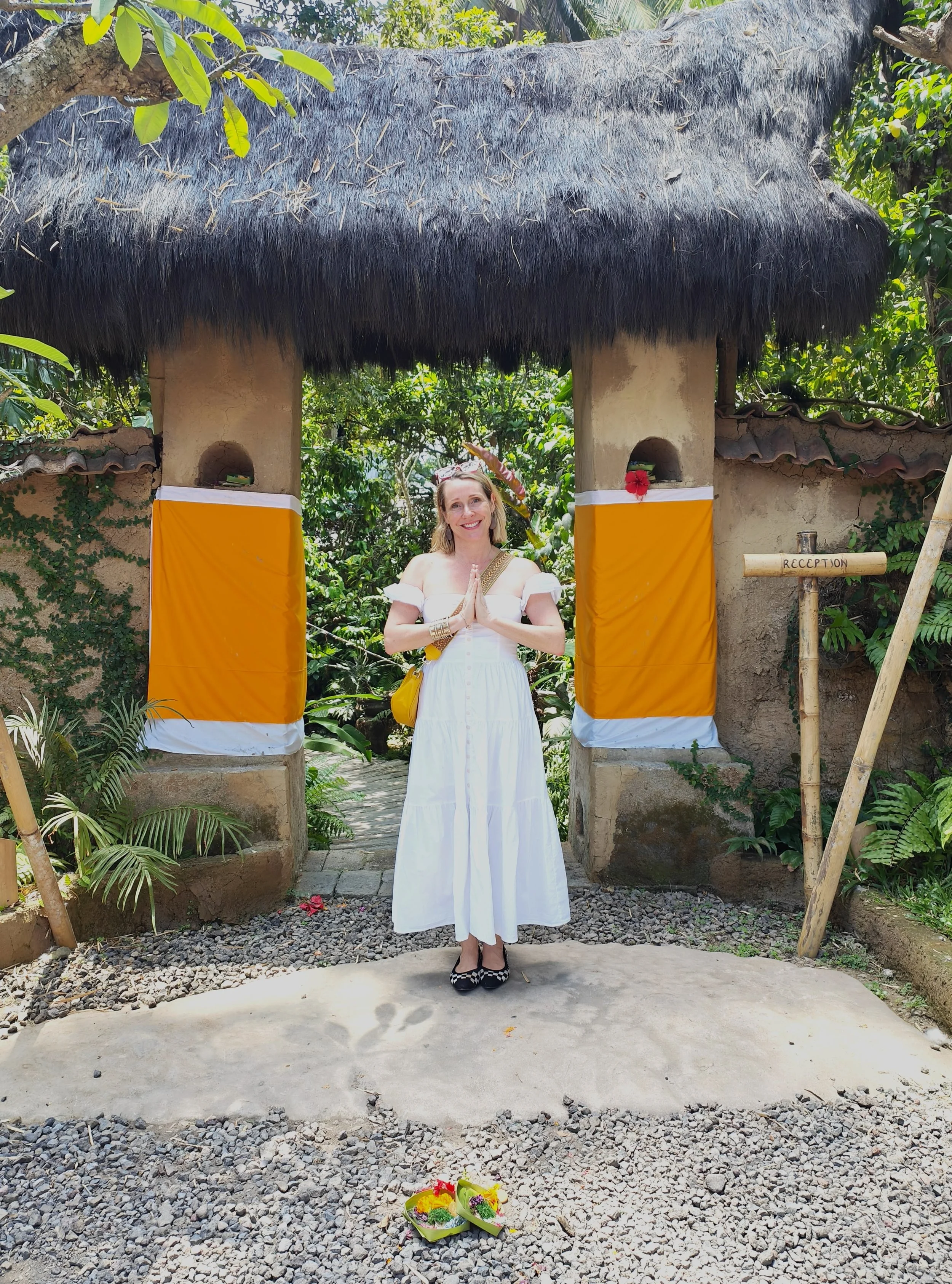 Woman in a white dress outside a temple