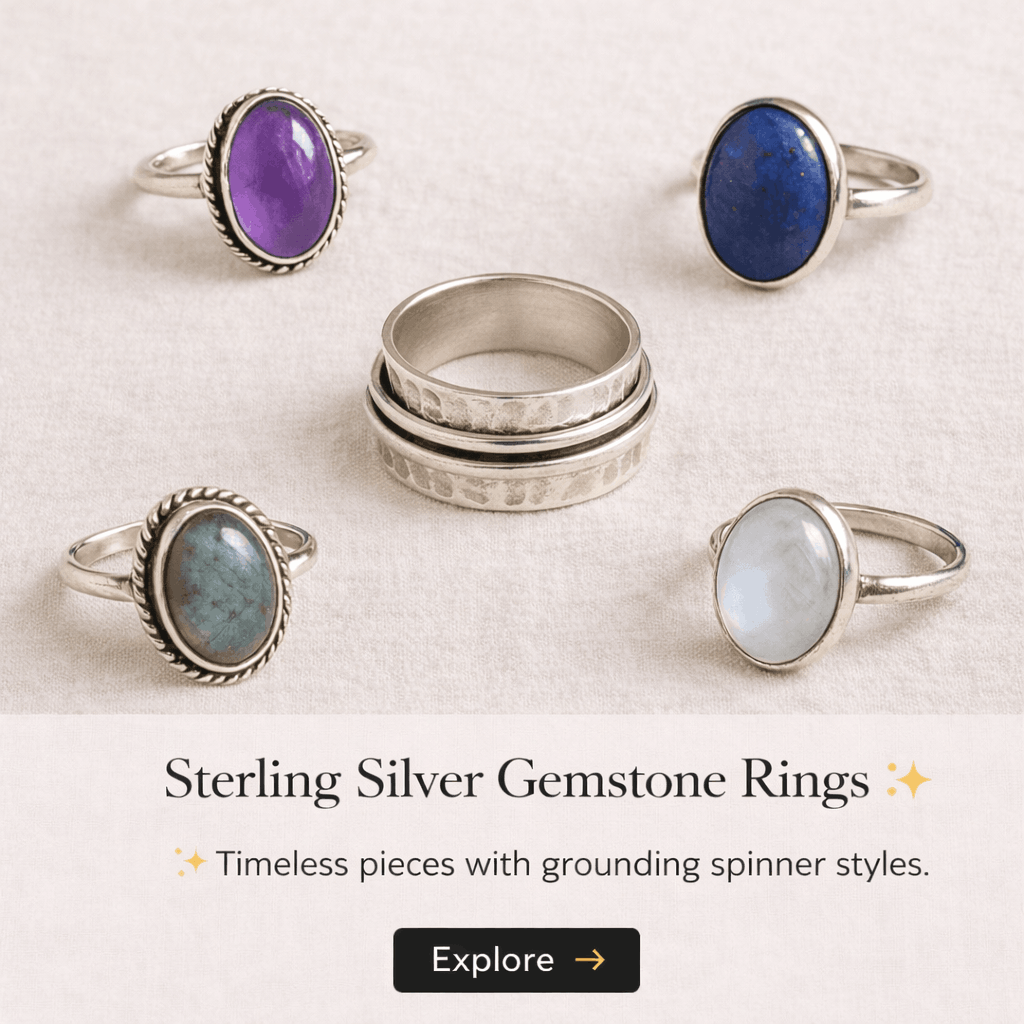 A collection of five sterling silver gemstone rings with oval stones in purple, blue, green, and white, displayed on a light fabric background.