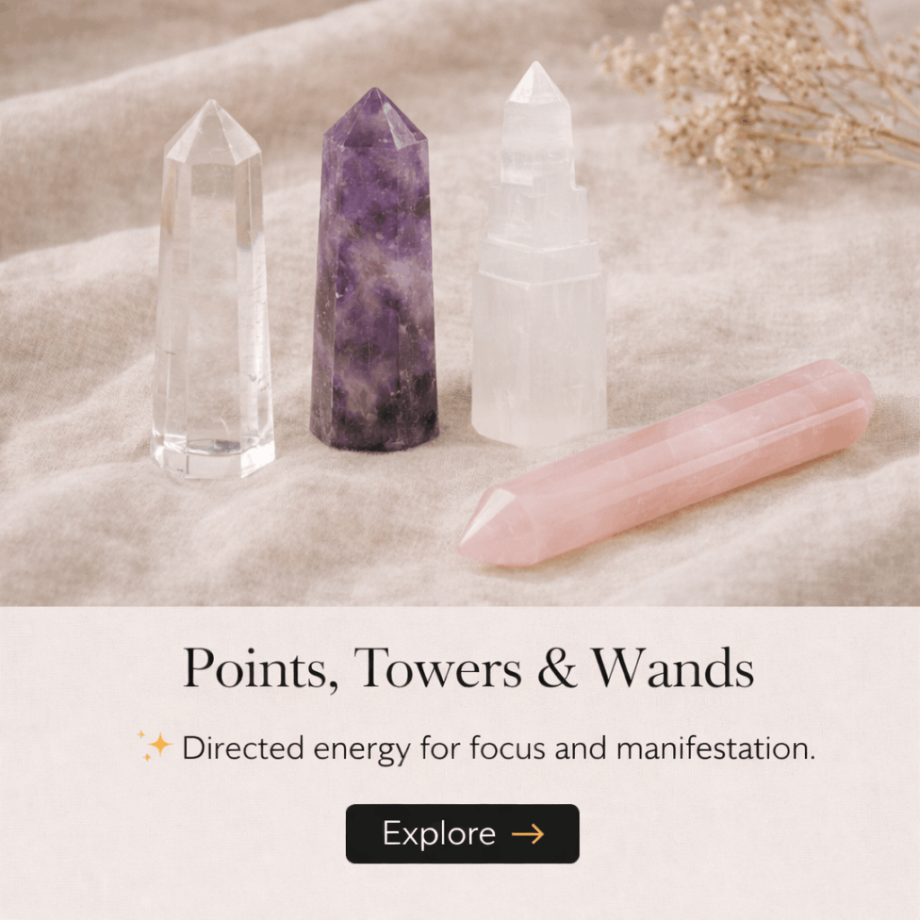 Four sculpted crystals of different colors and sizes arranged on a soft fabric surface, with text underneath that reads "Points, Towers & Wands" and a button labeled "Explore".