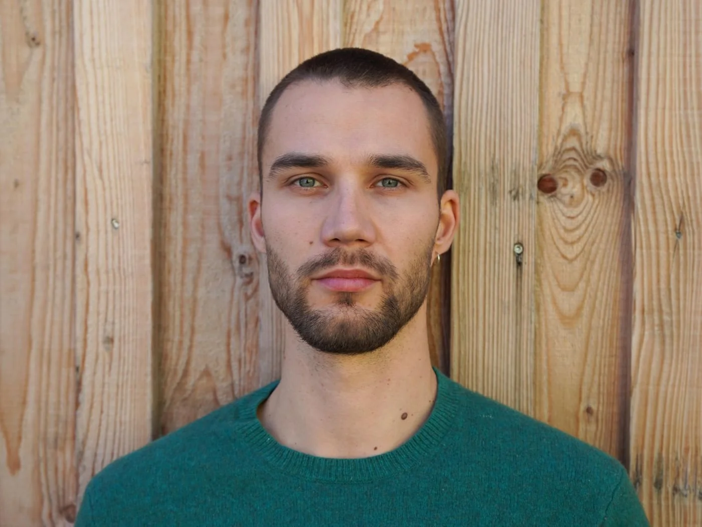 Junge Person vor Holzwand, nahaufnahme