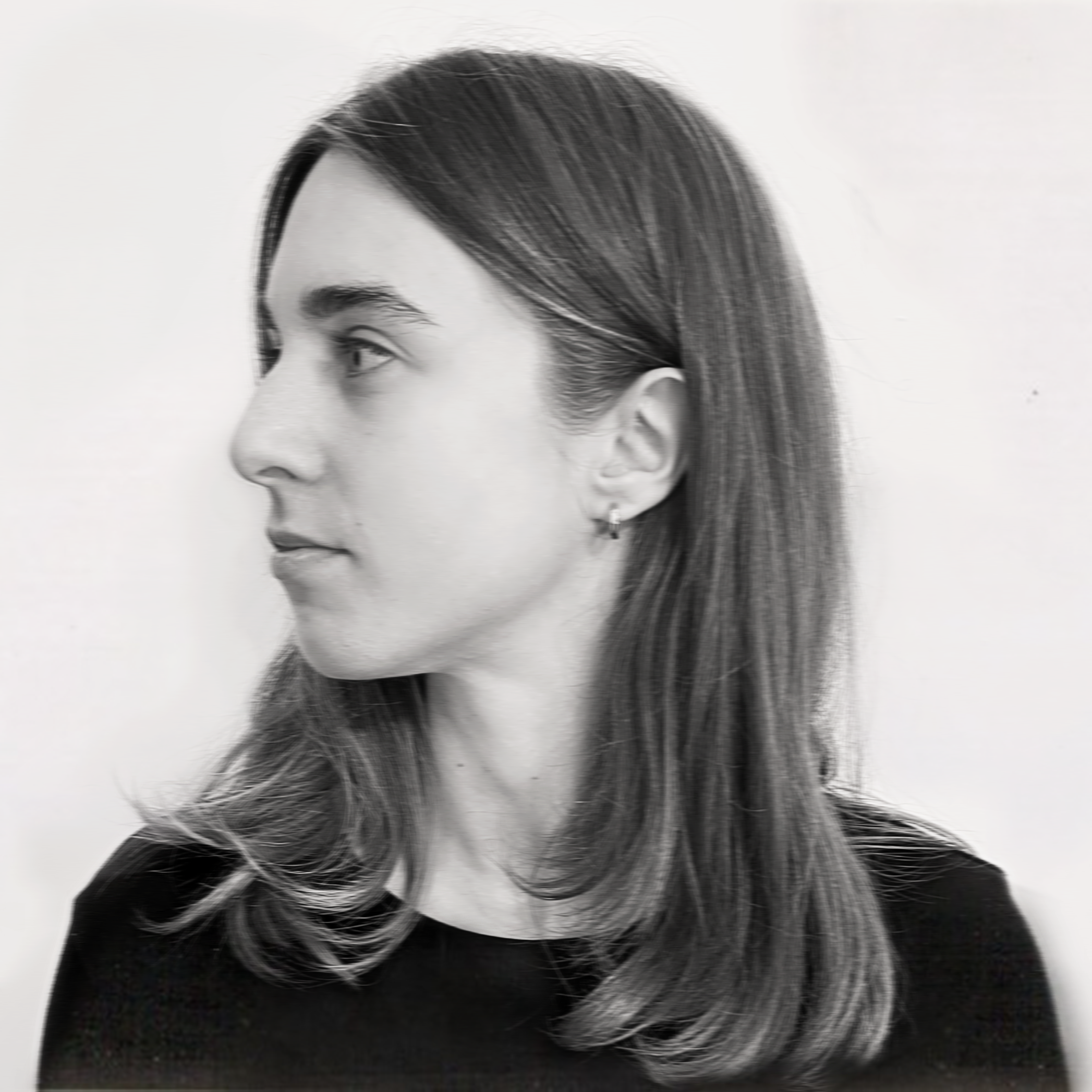 Black and white profile portrait of a woman with straight shoulder-length hair, wearing a black top and small hoop earrings, facing left against a plain background.