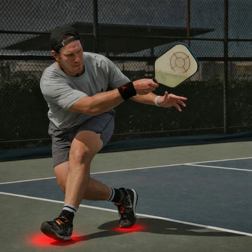 Pickleball player on court; podiatrist, chiropodist, sports injury treatment, & foot pain relief for plantar fasciitis, metatarsalgia, sesamoiditis using shockwave, custom orthotics & rehab in St. Catharines at Canadian Foot Clinic & Orthotic Centre