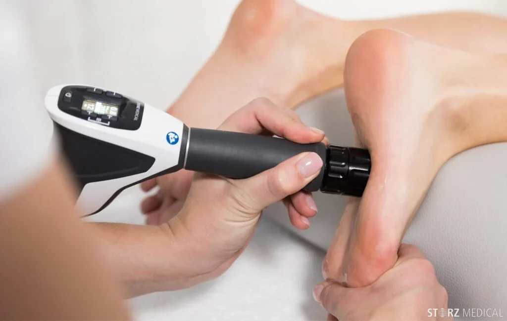 Trusted chiropodist at Canadian Foot Clinic & Orthotic Centre in St. Catharines applies shockwave therapy to the heel for plantar fasciitis and heel pain relief; clinical foot care, podiatrist, custom orthotics, accelerate healing.