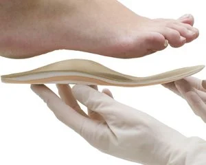 Trusted chiropodist at Canadian Foot Clinic & Orthotic Centre in St. Catharines fits a custom orthotic insole to relieve foot pain; clinical podiatry, custom orthotics, plantar fasciitis care.