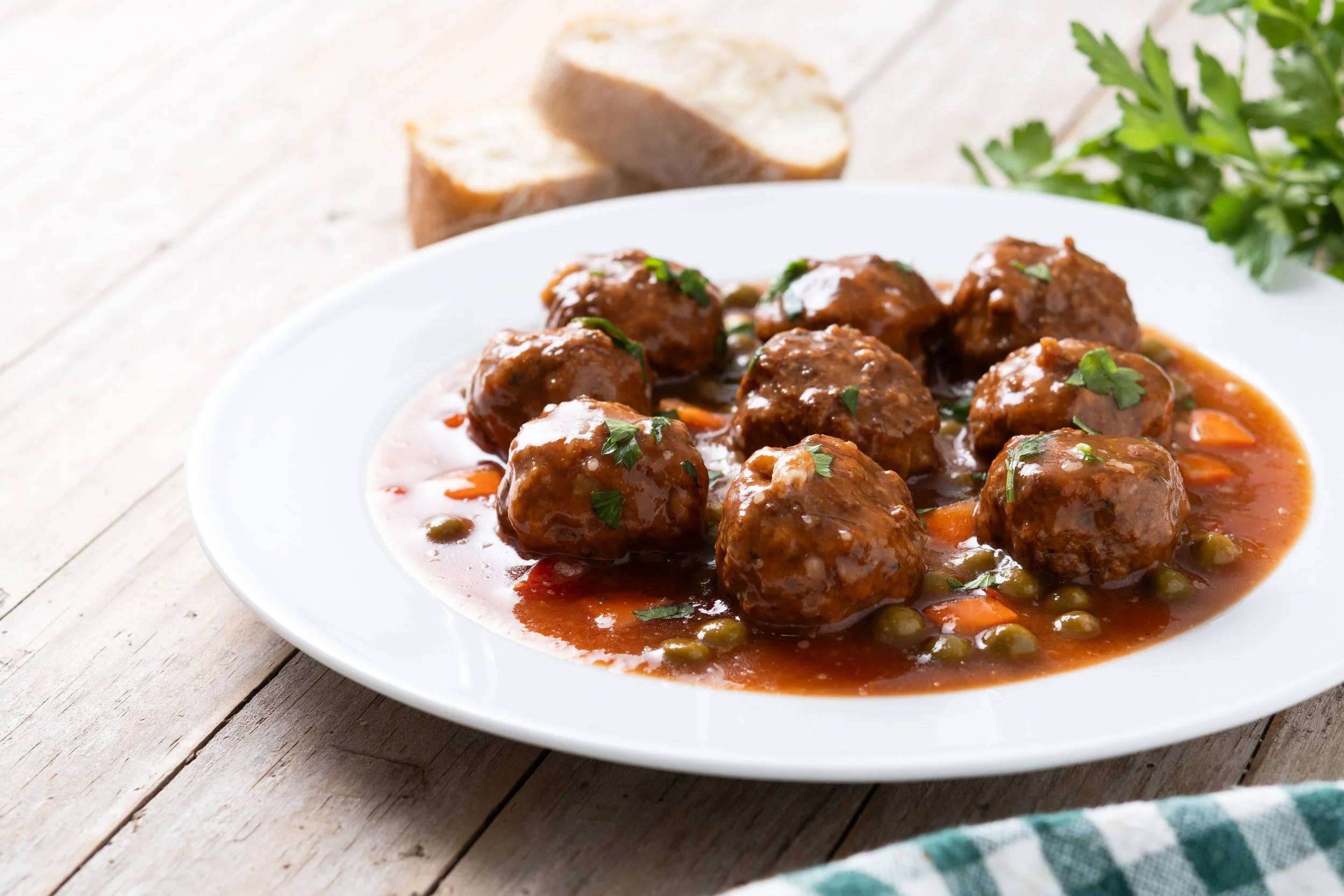 meatballs-green-peas-carrot-with-tomato-sauce-wooden-table.jpg