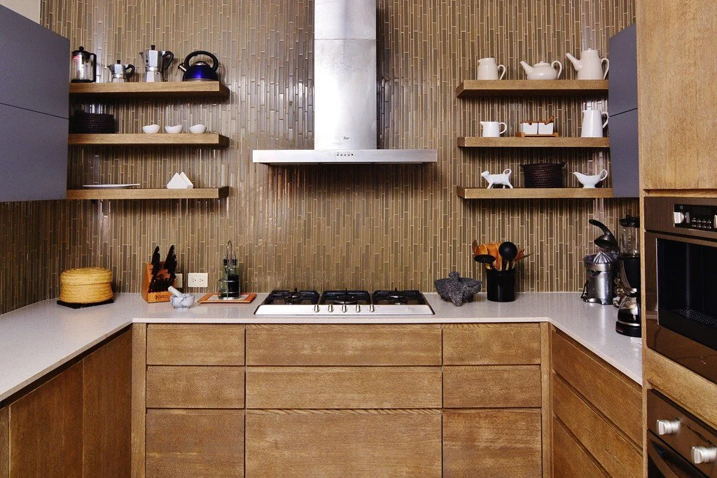 Modern kitchen with wooden cabinets, open shelves, a stainless steel range hood, and various kitchen appliances and decorations.